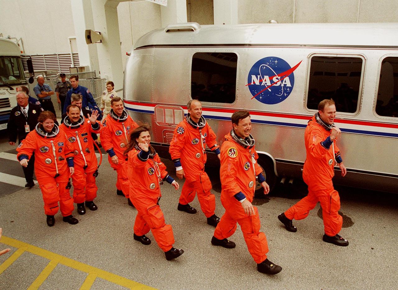 Waving to onlookers, the STS-101 crew eagerly walk to the waiting Astrovan that will take them to Launch Pad 39A and the second attempt at liftoff of Space Shuttle Atlantis. In their orange launch and entry suits, they are (left to right) Mission Specialists Susan J. Helms, Yury Usachev, James S. Voss, Mary Ellen Weber and Jeffrey N. Williams; Pilot Scott J. Horowitz; and Commander James D. Halsell Jr. The first launch attempt on April 24 was scrubbed due to unfavorable weather conditions. The mission will take the crew to the International Space Station to deliver logistics and supplies and to prepare the Station for the arrival of the Zvezda Service Module, expected to be launched by Russia in July 2000. Also, the crew will conduct one space walk. This will be the third assembly flight to the Space Station. Liftoff is targeted for 3:52 p.m. EDT. The mission is expected to last about 10 days, with Atlantis landing at KSC Saturday, May 6, about 11:53 a.m. EDT