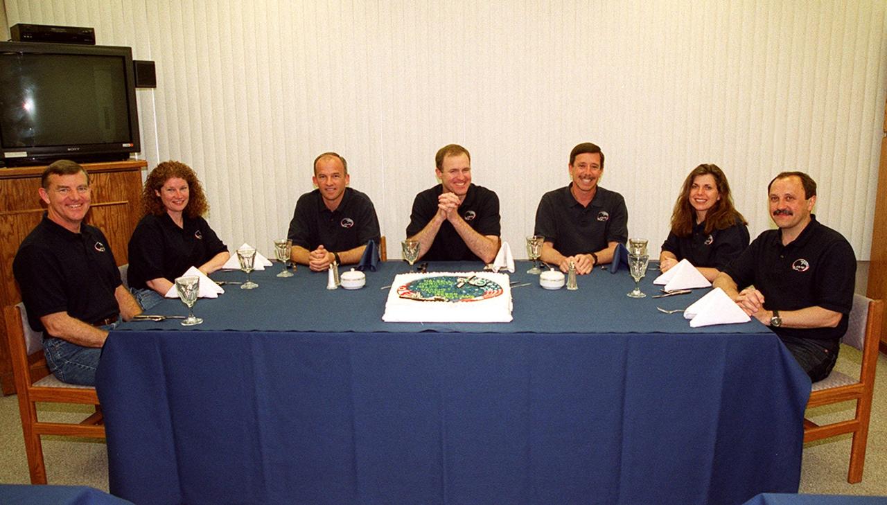 In the Operations and Checkout Building, the STS-101 crew gathers for a snack before suiting up for launch for the third time. The previous two launch attempts were scrubbed due to high cross winds at the Shuttle Landing Facility. From left are Mission Specialists James S. Voss, Susan J. Helms and Jeffrey N. Williams; Commander James D. Halsell Jr.; Pilot Scott J. Horowitz; and Mission Specialists Mary Ellen Weber and Yury Usachev of Russia. The mission will take the crew to the International Space Station to deliver logistics and supplies and prepare the Station for the arrival of the Zvezda Service Module. Also, the crew will conduct one space walk. This is the third assembly flight to the Space Station. After the 10-day mission, Atlantis is expected to land at KSC May 6 at about 12:03 p.m. EDT