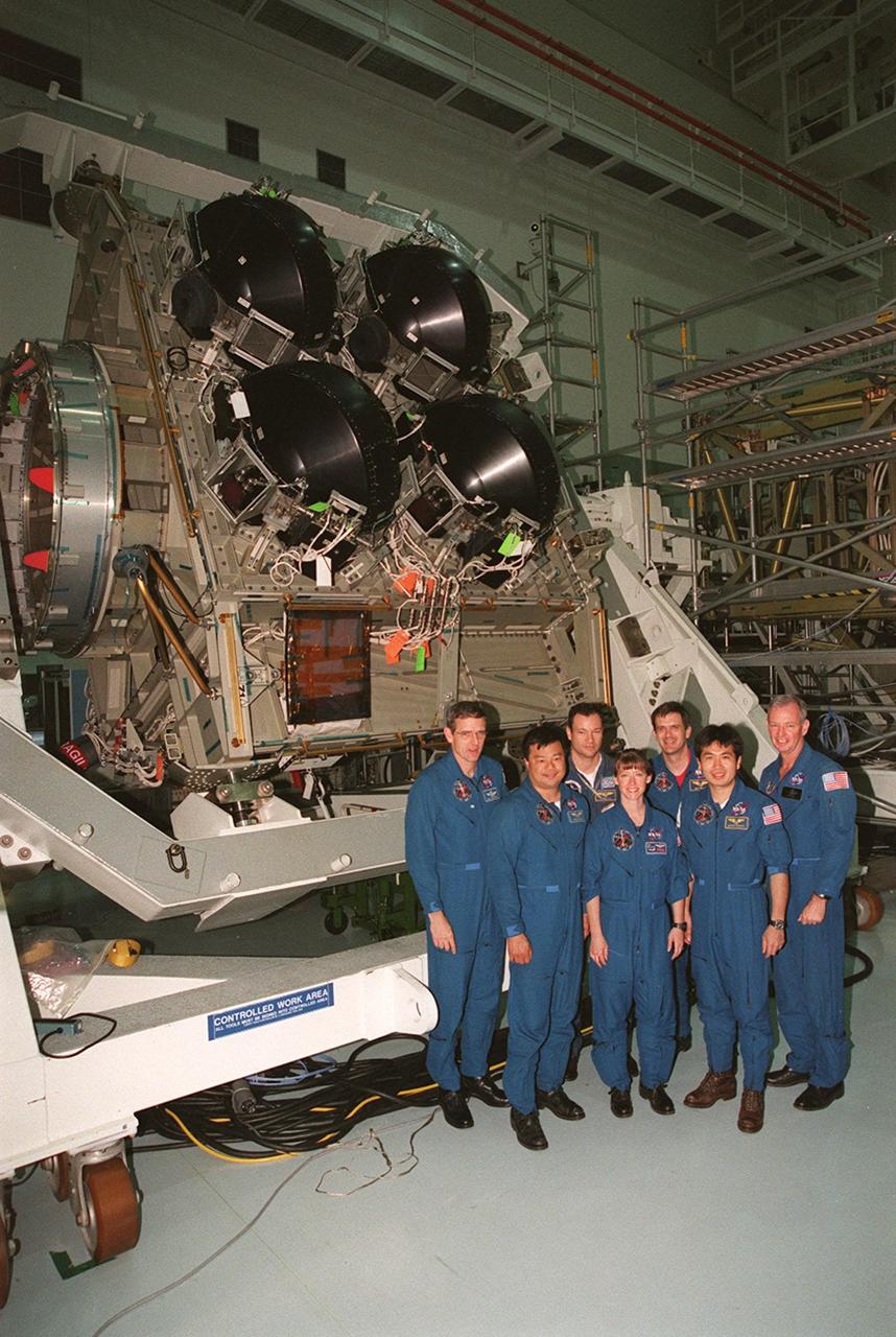 KENNEDY SPACE CENTER, FLA. -- The STS-92 crew pose in front of the Integrated Truss Structure Z1, an element of the International Space Station that will be part of the mission payload. STS-92 is the fifth U.S. flight in the construction of the International Space Station. Standing left to right are Mission Specialists William S. McArthur Jr., Leroy Chiao, and Michael E. Lopez-Alegria; Pilot Pamela A. Melroy; Mission Specialists Peter J.K. Wisoff and Koichi Wakata; and Commander Brian Duffy. Wakata is with the National Space Development Agency of Japan. The Z1 is an early exterior framework to allow the first U.S. solar arrays on a future flight to be temporarily installed on Unity for early power. Another part of the payload is a pressurized mating adapter, PMA-3, to provide a Shuttle docking port for solar array installation on the sixth ISS flight and Lab installation on the seventh ISS flight. Launch of STS-92 is scheduled for Sept. 21, 2000