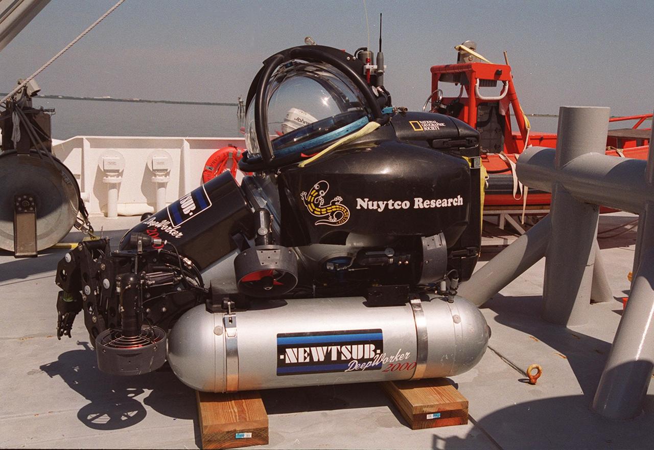 The one-man submarine dubbed DeepWorker 2000 sits on the deck of Liberty Star, one of two KSC solid rocket booster recovery ships. The sub is being tested on its ability to duplicate the sometimes hazardous job United Space Alliance (USA) divers perform to recover the expended boosters in the ocean after a launch. The boosters splash down in an impact area about 140 miles east of Jacksonville and after recovery are towed back to KSC for refurbishment by the specially rigged recovery ships. DeepWorker 2000 was built by Nuytco Research Ltd., North Vancouver, British Columbia. It is 8.25 feet long, 5.75 feet high, and weighs 3,800 pounds. USA is a prime contractor to NASA for the Space Shuttle program