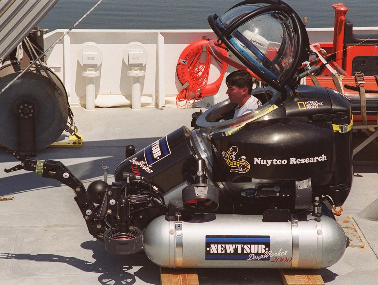 The one-man submarine dubbed DeepWorker 2000 sits on the deck of Liberty Star, one of two KSC solid rocket booster recovery ships. Inside the sub is the pilot, Anker Rasmussen. The sub is being tested on its ability to duplicate the sometimes hazardous job United Space Alliance (USA) divers perform to recover the expended boosters in the ocean after a launch. The boosters splash down in an impact area about 140 miles east of Jacksonville and after recovery are towed back to KSC for refurbishment by the specially rigged recovery ships. DeepWorker 2000 was built by Nuytco Research Ltd., North Vancouver, British Columbia. It is 8.25 feet long, 5.75 feet high, and weighs 3,800 pounds. USA is a prime contractor to NASA for the Space Shuttle program