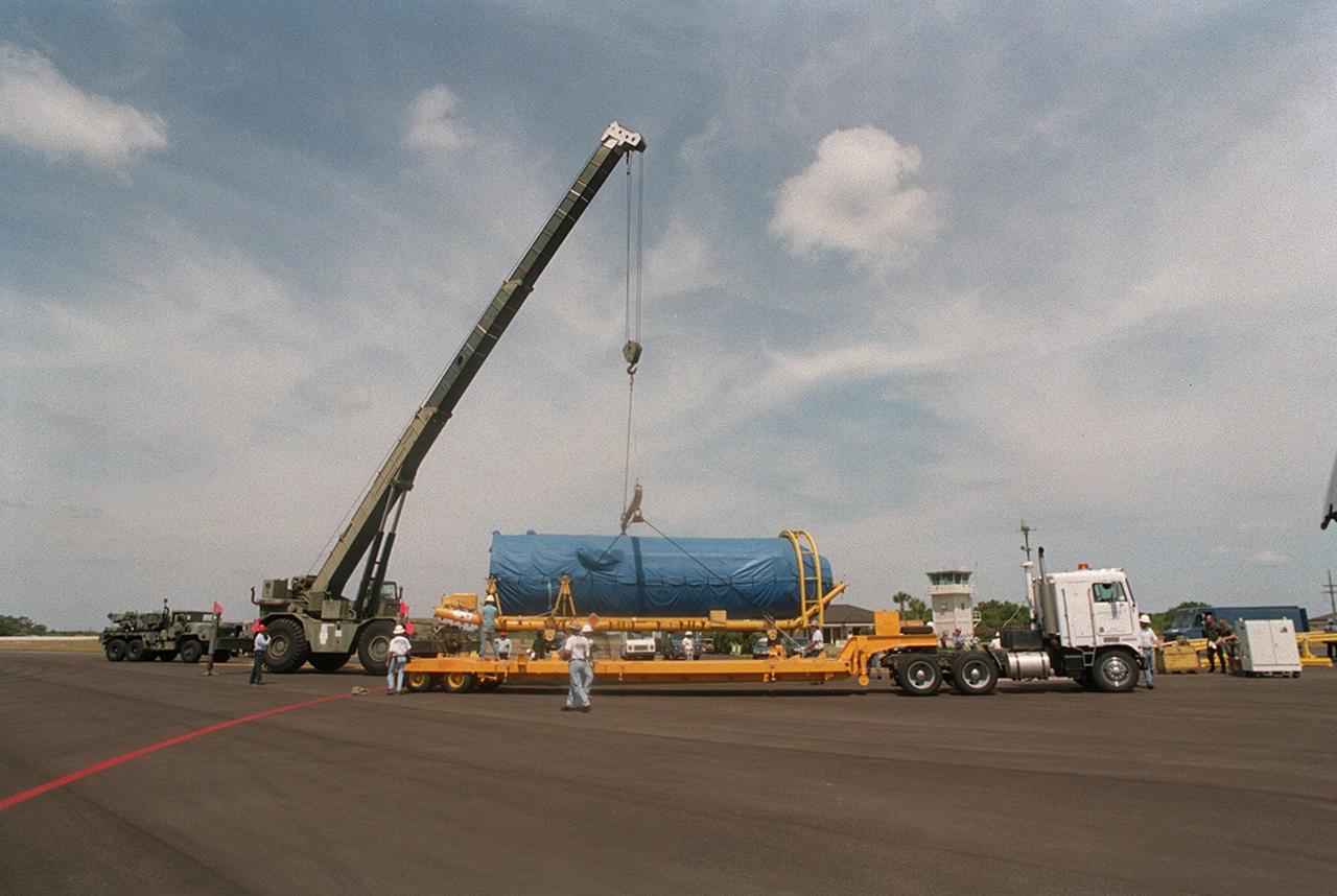 At Cape Canaveral Air Force skid strip, the Centaur upper stage is placed aboard a transporter after arriving aboard a Russian cargo plane, the Antenov 124. The Centaur will be coupled with an Atlas IIA to launch the latest Tracking and Data Relay Satellite (TDRS) June 29 from Cape Canaveral Air Force Station. The Centaur, manufactured and operated by Lockheed Martin, is 3.05 m (10 ft) in diameter and 10.0 m (33-ft) long. It uses liquid hydrogen (LH2) and liquid oxygen (LO2) propellants