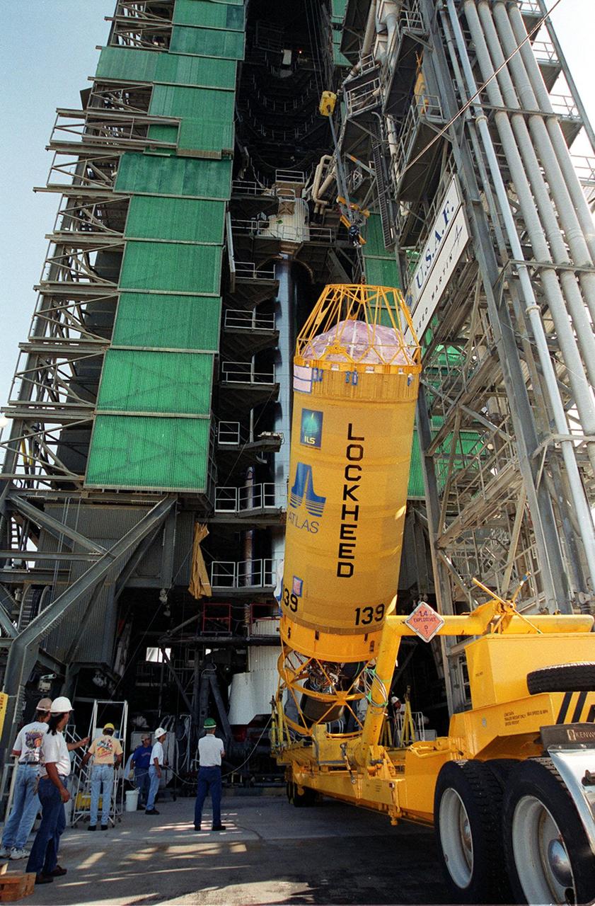 At Launch Pad 36A, Cape Canaveral Air Force Station, a Centaur rocket is raised to a vertical position before lifting it up the launch tower. It will be mated with the lower stage Atlas IIA rocket, already in the tower, to launch the latest Tracking and Data Relay Satellite (TDRS) June 29 from CCAFS. The TDRS is one of three (labeled H, I and J) being built in the Hughes Space and Communications Company Integrated Satellite Factory in El Segundo, Calif. The new satellites will augment the TDRS system’s existing Sand Ku-band frequencies by adding Ka-band capability. TDRS will serve as the sole means of continuous, high-data-rate communication with the space shuttle, with the International Space Station upon its completion, and with dozens of unmanned scientific satellites in low earth orbit