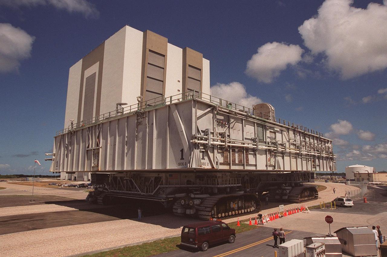 KENNEDY SPACE CENTER, FLA. -- A crawler-transporter with mobile launcher platform on top moves along a portion of the once-buried crawlerway toward the Vehicle Assembly Building (VAB). The road was restored as part of KSC’s Safe Haven project. High bay 2 provides a third stacking area. The primary goal of the Safe Haven construction project was to strengthen readiness for hurricane season by expanding the VAB’s storage capacity. The new area, in high bay 2, will allow NASA to preassemble stacks and still have room in the VAB to pull a Shuttle back from the pad if severe weather threatens. Potential rollouts of the Space Shuttle to the launch pad from high bay 2 will involve making a turn around the north side of the VAB in contrast to the straight rollouts from high bays 1 and 3, on the east side of the VAB facing the launch pads