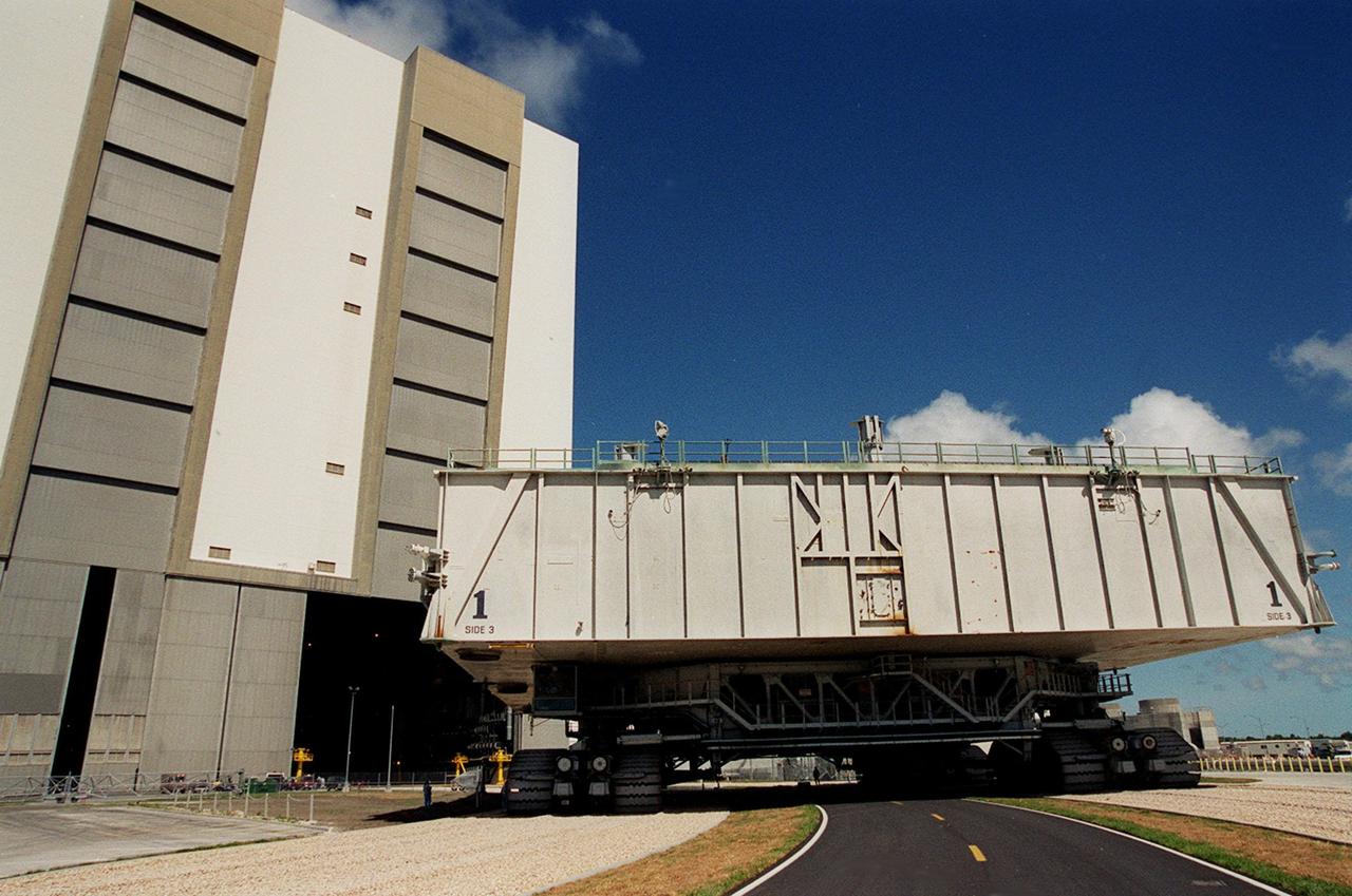 KENNEDY SPACE CENTER, FLA. -- On a portion of the once-buried crawlerway that was recently restored, a crawler-transporter with mobile launcher platform on top turns toward the Vehicle Assembly Building (VAB) high bay 2. The road was restored as part of KSC’s Safe Haven project. High bay 2 provides a third stacking area. The primary goal of the Safe Haven construction project was to strengthen readiness for hurricane season by expanding the VAB’s storage capacity. The new area, in high bay 2, will allow NASA to preassemble stacks and still have room in the VAB to pull a Shuttle back from the pad if severe weather threatens. Potential rollouts of the Space Shuttle to the launch pad from high bay 2 will involve making a turn around the north side of the VAB in contrast to the straight rollouts from high bays 1 and 3, on the east side of the VAB facing the launch pads