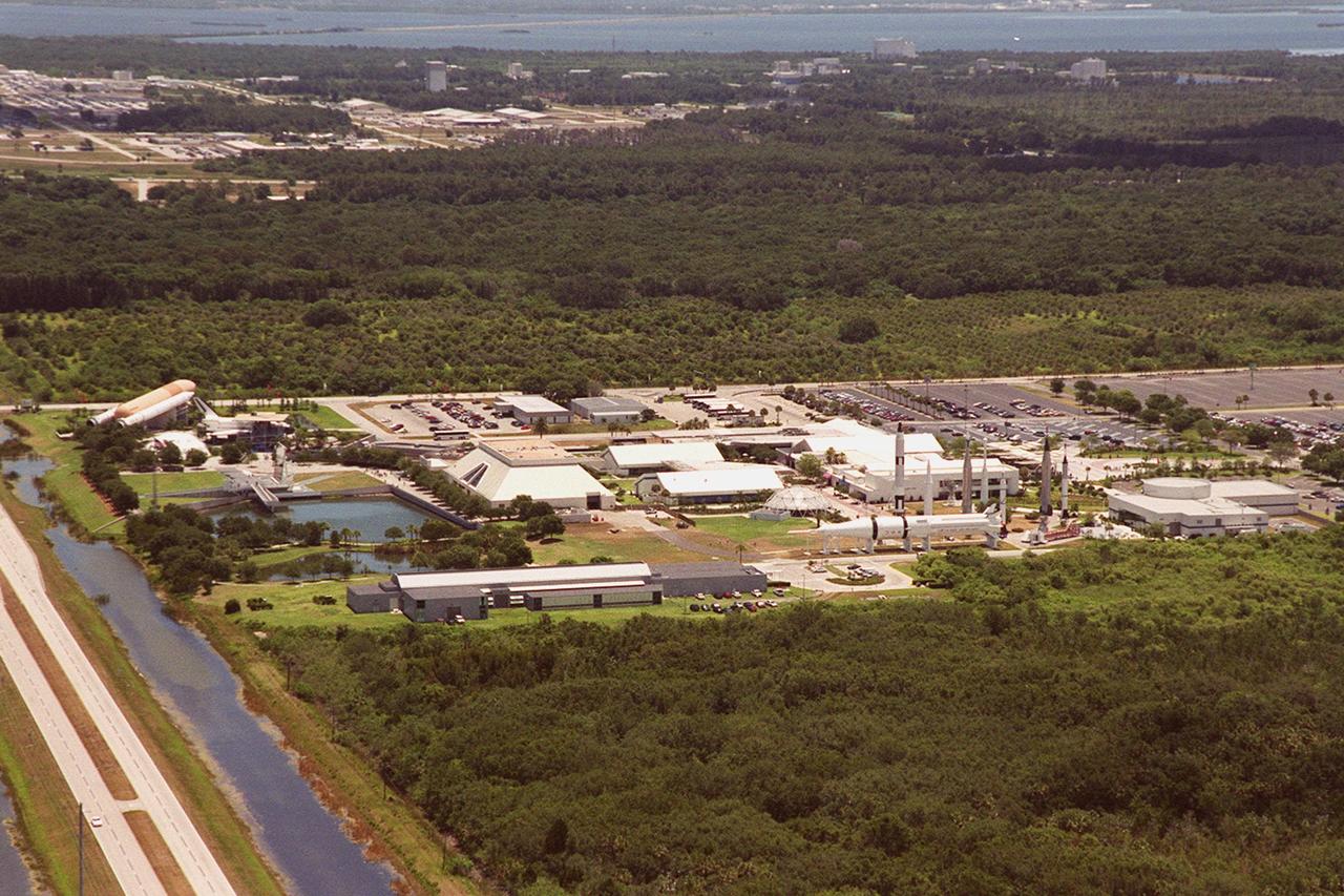 This aerial view is of Kennedy Space Center's Visitor Complex. The full-scale replicas of the Space Shuttle external tank, solid rocket boosters and orbiter are located to the left of the various buildings which comprise the complex. The long narrow building in the left foreground is the Center for Space Education which houses the Educators Resource Center and the Astronauts Memorial Foundation