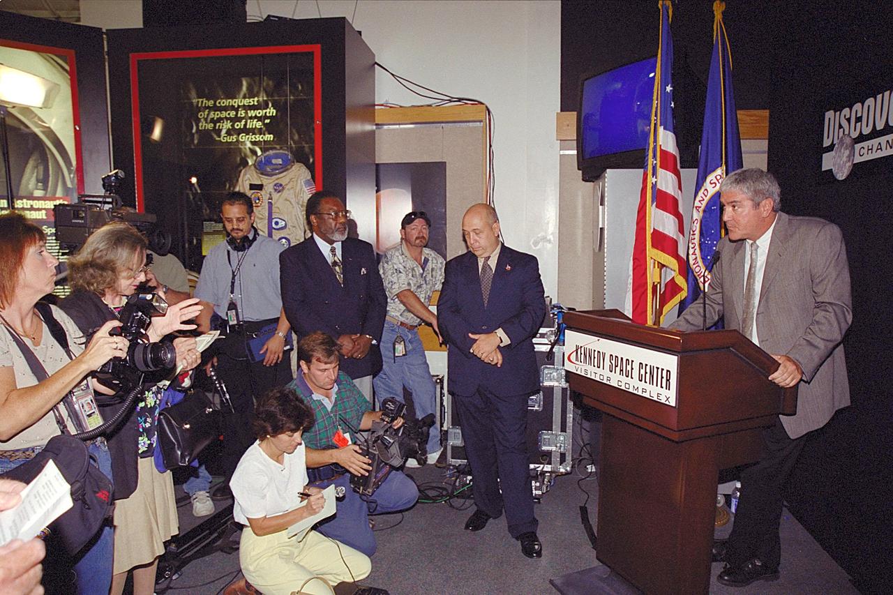 Media gather at the KSC Visitor Complex for the kickoff of the Discovery Channel's Liberty Bell 7 Space Capsule Exhibit, which will open to the public on Saturday, June 17. At the podium is Mike Quattrone, executive vice president and general manager, Discovery Channel.; Standing to the left of the podium is Rick Abramson, president and chief operating officer of Delaware North Parks Services of Spaceport, Inc., and far left, Jim Jennings, deputy director of Kennedy Space Center.; Liberty Bell 7 launched U.S. Air Force Captain Virgil “Gus” Grissom July 21, 1961 on a mission that lasted 15 minutes and 37 seconds before sinking to the floor of the Atlantic Ocean, three miles deep. It lay undetected for nearly four decades before a Discovery Channel expedition located it and recovered it. The space capsule is now restored and preserved, and part of an interactive exhibit touring science centers and museums in 12 cities throughout the United States until 2003. The exhibit includes hands-on elements such as a capsule simulator, a centrifuge, and ROV pilot