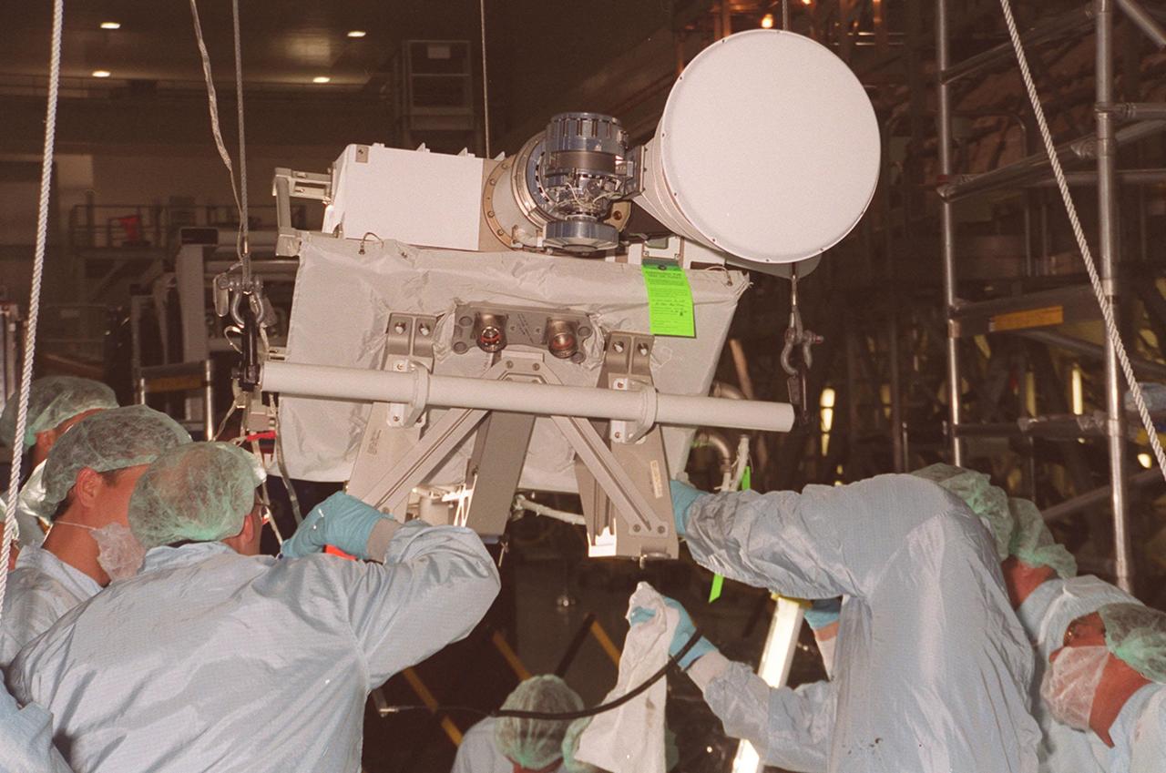 In the Space Station Processing Facility, workers prepare an S-band Antenna Support Assembly (SASA) to be lifted and moved to the Integrated Truss Structure (ITS) Z1, an element of the International Space Station. The antenna will be attached to the truss. The SASA antenna is primarily for local communications between the orbiter and Space Station. The Z1 is an early exterior framework to allow the first U.S. solar arrays, on mission STS-97, flight 4A, to be temporarily installed on Unity for early power. The Z1 is scheduled on mission STS-92, the fifth flight to the Space Station, in the fall