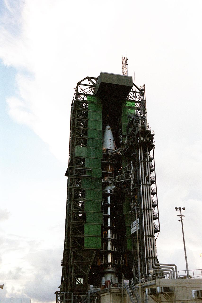 The nose fairing covering the Tracking and Data Relay Satellite (TDRS-H) is close to the top of the launch tower at Launch Pad 36A, Cape Canaveral Air Force Station. It is being lifted to mate with the Atlas IIA/Centaur rocket, which is already stacked, for launch on June 29. The satellite will augment the TDRS system’s existing Sand Ku-band frequencies by adding Ka-band capability. TDRS will serve as the sole means of continuous, high-data-rate communication with the Space Shuttle, with the International Space Station upon its completion, and with dozens of unmanned scientific satellites in low earth orbit