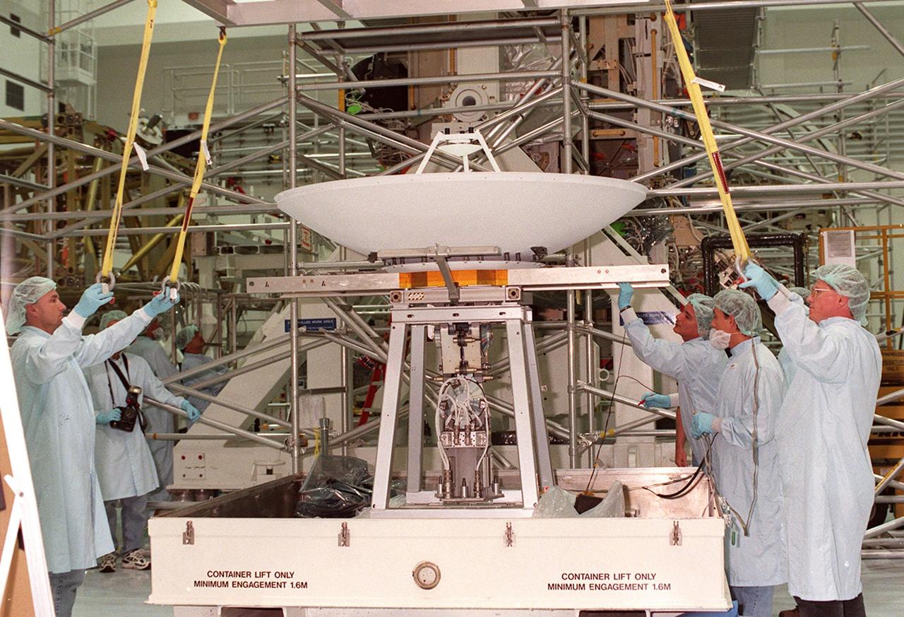 In the Space Shuttle Processing Facility, workers get ready to attach cables to a high-gain antenna that will be lifted and attached to the Integrated Truss Structure (ITS) Z1. The Z1, part of the payload on mission STS-92 (flight 3A) to be launched in mid-fall, is an early exterior framework for the International Space Station. It will allow the first U.S. solar arrays, on mission STS-97 (flight 4A), to be temporarily installed on Unity for early power