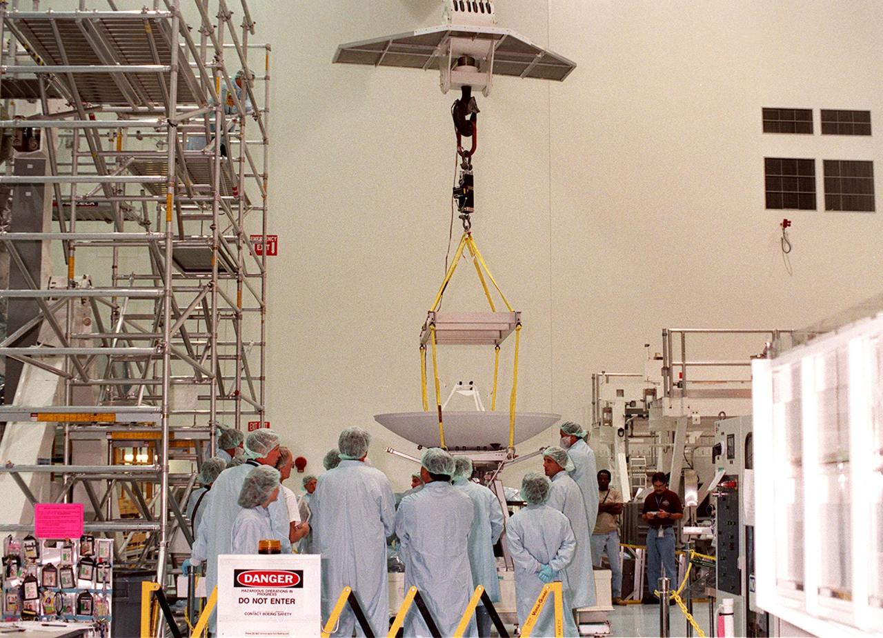 In the Space Shuttle Processing Facility, an overhead crane begins lifting a high-gain antenna to move it to the Integrated Truss Structure (ITS) Z1, to which it will be attached. The Z1, part of the payload on mission STS-92 (flight 3A) to be launched in mid-fall, is an early exterior framework for the International Space Station. It will allow the first U.S. solar arrays, on mission STS-97 (flight 4A), to be temporarily installed on Unity for early power