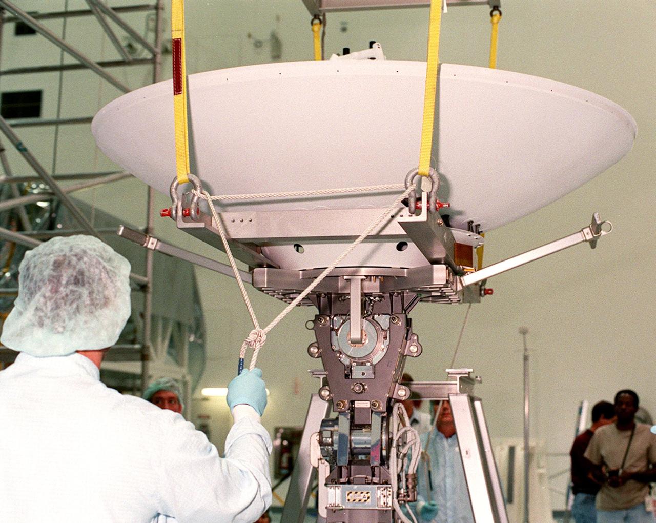 In the Space Shuttle Processing Facility, a worker checks a rope attached to a high-gain antenna before it moves to the Integrated Truss Structure (ITS) Z1, to which it will be attached. The Z1, part of the payload on mission STS-92 (flight 3A) to be launched in mid-fall, is an early exterior framework for the International Space Station. It will allow the first U.S. solar arrays, on mission STS-97 (flight 4A), to be temporarily installed on Unity for early power
