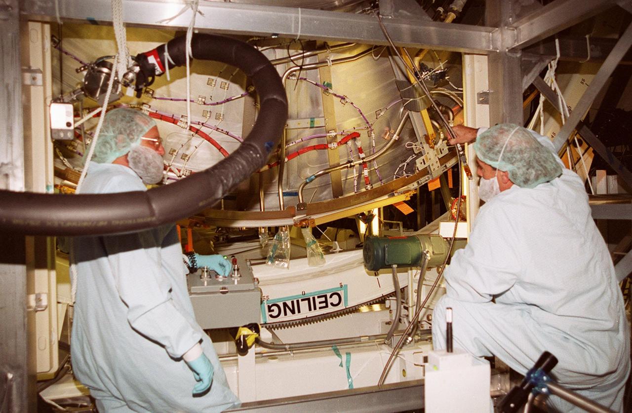 KENNEDY SPACE CENTER, FLA. -- In the Space Station Processing Facility, workers check the U.S. Laboratory Destiny as it rotates, with its ceiling now on the underside. A component of the International Space Station, Destiny is scheduled to fly on mission STS-98 in early 2001. During the mission, the crew will install the Lab during a series of three space walks. The STS-98 mission will provide the station with science research facilities and expand its power, life support and control capabilities. The U.S. Lab module continues a long tradition of microgravity materials research, first conducted by Skylab and later Shuttle and Spacelab missions. Destiny is expected to be a major feature in future research, providing facilities for biotechnology, fluid physics, combustion, and life sciences research