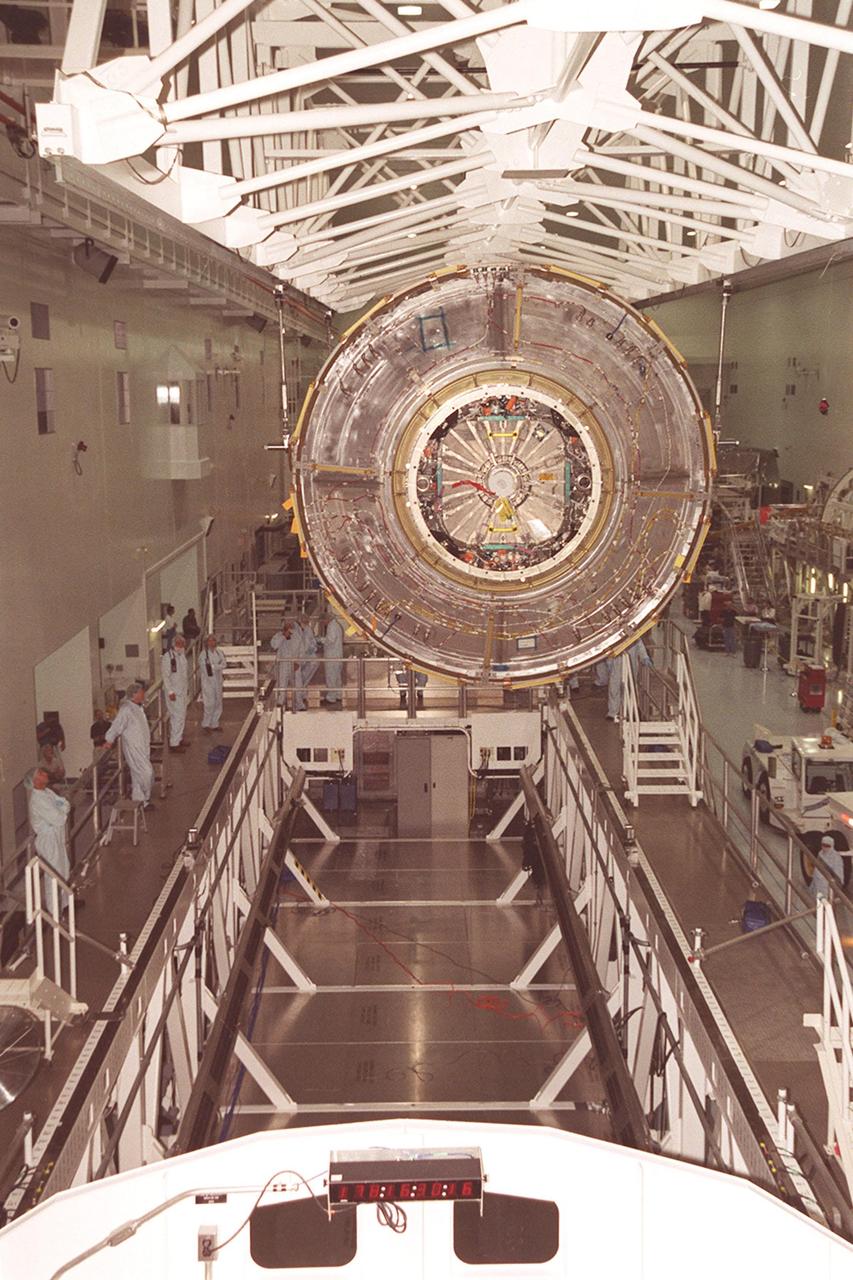 KENNEDY SPACE CENTER, Fla. -- In the Space Station Processing Facility, the U.S. Lab Destiny is lowered toward the weigh stand below. A component of the International Space Station, Destiny is scheduled to fly on mission STS-98 in early 2001. During the mission, the crew will install the Lab during a series of three space walks. The STS-98 mission will provide the station with science research facilities and expand its power, life support and control capabilities. The U.S. Lab module continues a long tradition of microgravity materials research, first conducted by Skylab and later Shuttle and Spacelab missions. Destiny is expected to be a major feature in future research, providing facilities for biotechnology, fluid physics, combustion, and life sciences research.