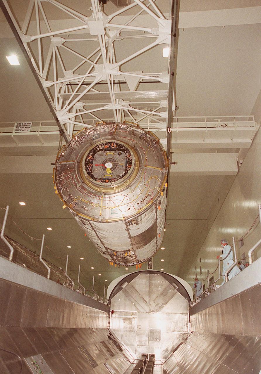 KENNEDY SPACE CENTER, FLA. -- In the Space Station Processing Facility, the U.S. Laboratory Destiny, a component of the International Space Station, is lowered into a payload canister for transfer to the Operations and Checkout Building where it will be tested in the altitude chamber. Destiny is scheduled to fly on mission STS-98 in early 2001. During the mission, the crew will install the Lab in the Space Station during a series of three space walks. The STS-98 mission will provide the Station with science research facilities and expand its power, life support and control capabilities. The U.S. Lab module continues a long tradition of microgravity materials research, first conducted by Skylab and later Shuttle and Spacelab missions. Destiny is expected to be a major feature in future research, providing facilities for biotechnology, fluid physics, combustion, and life sciences research