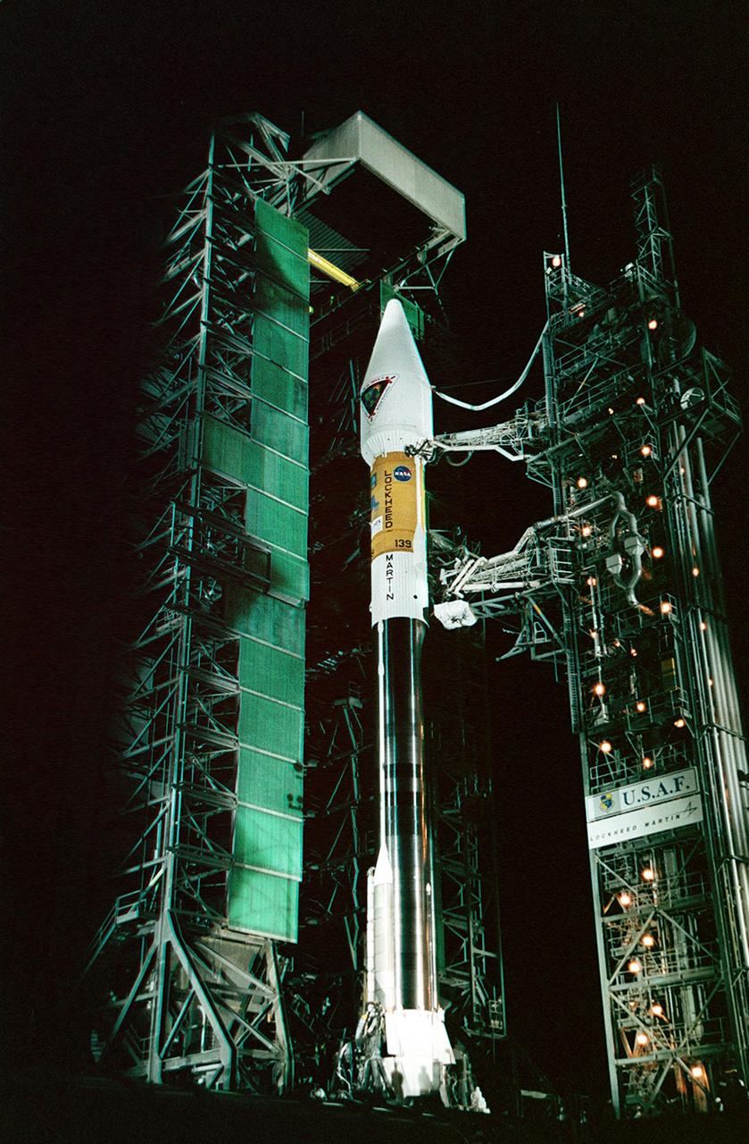 In the early morning hours on Launch Pad 36A, Cape Canaveral Air Force Station, the tower rolls back from NASA’s Tracking and Data Relay Satellite (TDRS-H) before liftoff atop an Atlas IIA/Centaur rocket. One of three satellites (labeled H, I and J) being built by the Hughes Space and Communications Company, the latest TDRS uses an innovative springback antenna design. A pair of 15-foot-diameter, flexible mesh antenna reflectors fold up for launch, then spring back into their original cupped circular shape on orbit. The new satellites will augment the TDRS system’s existing Sand Ku-band frequencies by adding Ka-band capability. TDRS will serve as the sole means of continuous, high-data-rate communication with the Space Shuttle, with the International Space Station upon its completion, and with dozens of unmanned scientific satellites in low earth orbit