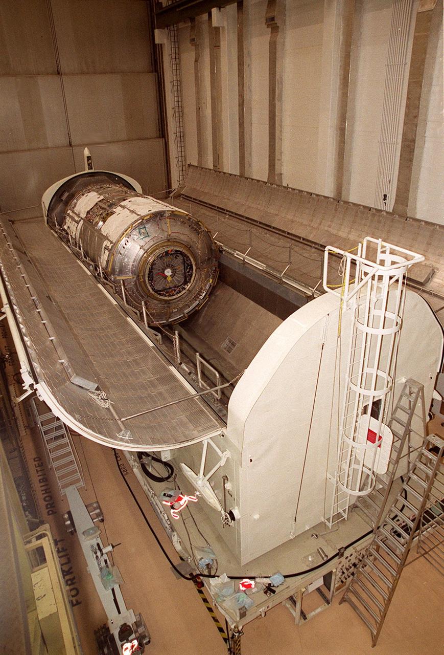 KENNEDY SPACE CENTER, FLA. -- In the Operations and Checkout Building (O&C), the doors of the payload canister open to reveal the U.S. Lab, named Destiny. The Lab will undergo testing in the altitude chamber in the O&C. Destiny is scheduled to fly on mission STS-98 in early 2001. During the mission, the crew will install the Lab in the Space Station during a series of three space walks. The STS-98 mission will provide the Station with science research facilities and expand its power, life support and control capabilities. The U.S. Lab module continues a long tradition of microgravity materials research, first conducted by Skylab and later Shuttle and Spacelab missions. Destiny is expected to be a major feature in future research, providing facilities for biotechnology, fluid physics, combustion, and life sciences research