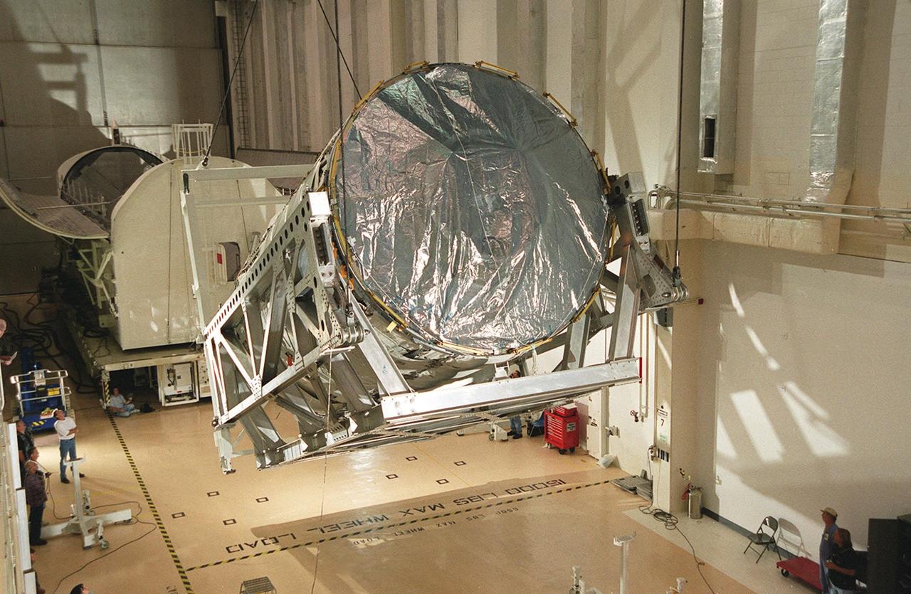 Resting in a rotation and handling fixture, the U.S. Lab, a component of the International Space Station, is lifted toward vertical. The Lab, named Destiny, will undergo testing in the altitude chamber in the Operations and Checkout Building. Behind the Lab is the payload canister which transported it from the Space Station Processing Facility. Destiny is scheduled to fly on mission STS-98 in early 2001. During the mission, the crew will install the Lab in the Space Station during a series of three space walks. The STS-98 mission will provide the Station with science research facilities and expand its power, life support and control capabilities. The U.S. Lab module continues a long tradition of microgravity materials research, first conducted by Skylab and later Shuttle and Spacelab missions. Destiny is expected to be a major feature in future research, providing facilities for biotechnology, fluid physics, combustion, and life sciences research