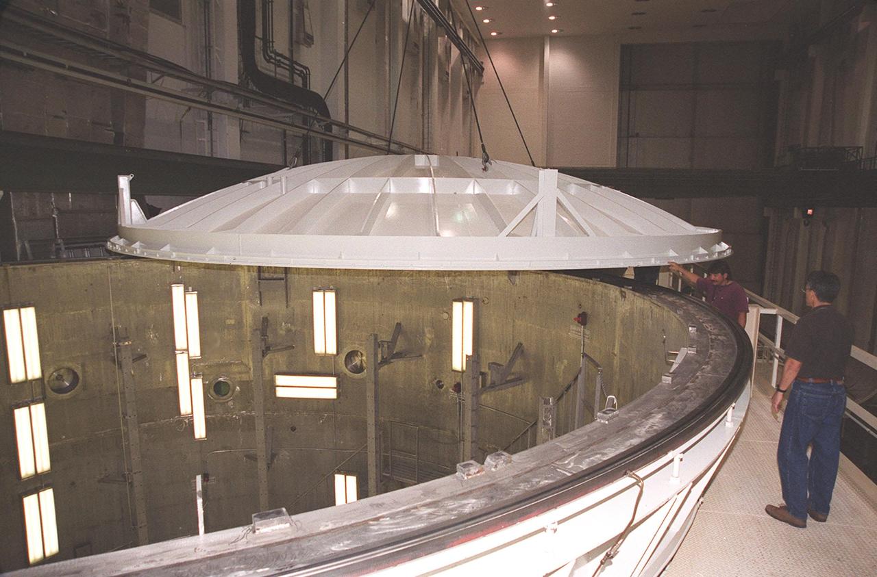 KENNEDY SPACE CENTER, FLA. -- An overhead crane moves the lid over the vacuum chamber containing the U.S. Lab, a component of the International Space Station. The 32,000-pound scientific research lab, named Destiny, is the first Space Station element to spend seven days in the renovated vacuum chamber for a leak test. Destiny is scheduled to be launched on Shuttle mission STS-98, the 5A assembly mission, targeted for Jan. 18, 2001. During the mission, the crew will install the Lab in the Space Station during a series of three space walks. The STS-98 mission will provide the Station with science research facilities and expand its power, life support and control capabilities. The U.S. Lab module continues a long tradition of microgravity materials research, first conducted by Skylab and later Shuttle and Spacelab missions. Destiny is expected to be a major feature in future research, providing facilities for biotechnology, fluid physics, combustion, and life sciences research