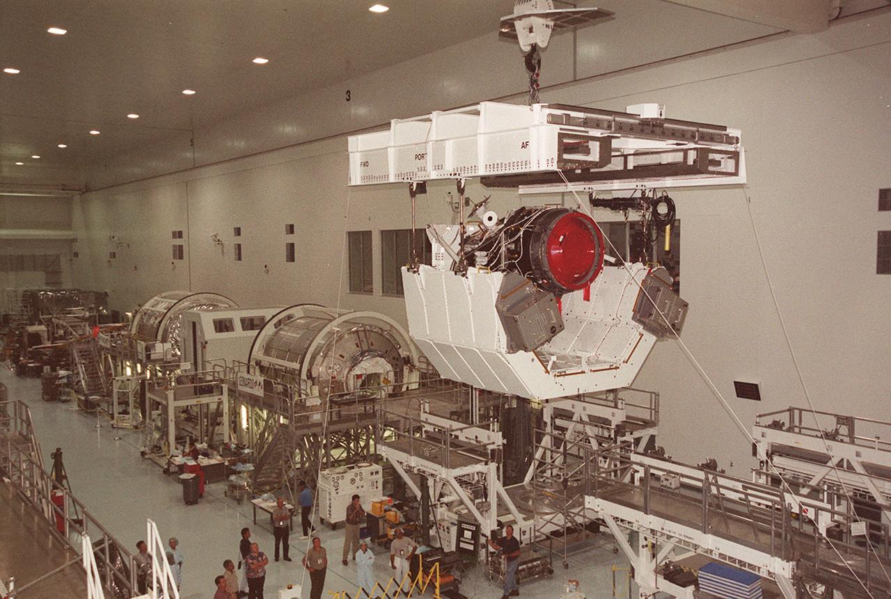 KENNEDY SPACE CENTER, FLA. -- In the Space Station Processing Facility, an overhead crane moves the Pressurized Mating Adapter-3 (PMA-3) to a payload canister for transport to the Orbiter Processing Facility.  The PMA-3, a component of the International Space Station, is part of the payload on Space Shuttle mission STS-92, scheduled to launch Oct. 5.  The mission will be the fifth flight to the Space Station, and the 100th Shuttle flight overall.  PMA-3 provides the Shuttle docking port for solar array installation on flight 4A (mission STS-97, scheduled for Nov. 30) and Lab installation on flight 5A (mission STS-98), scheduled for Jan. 18, 2001.)
