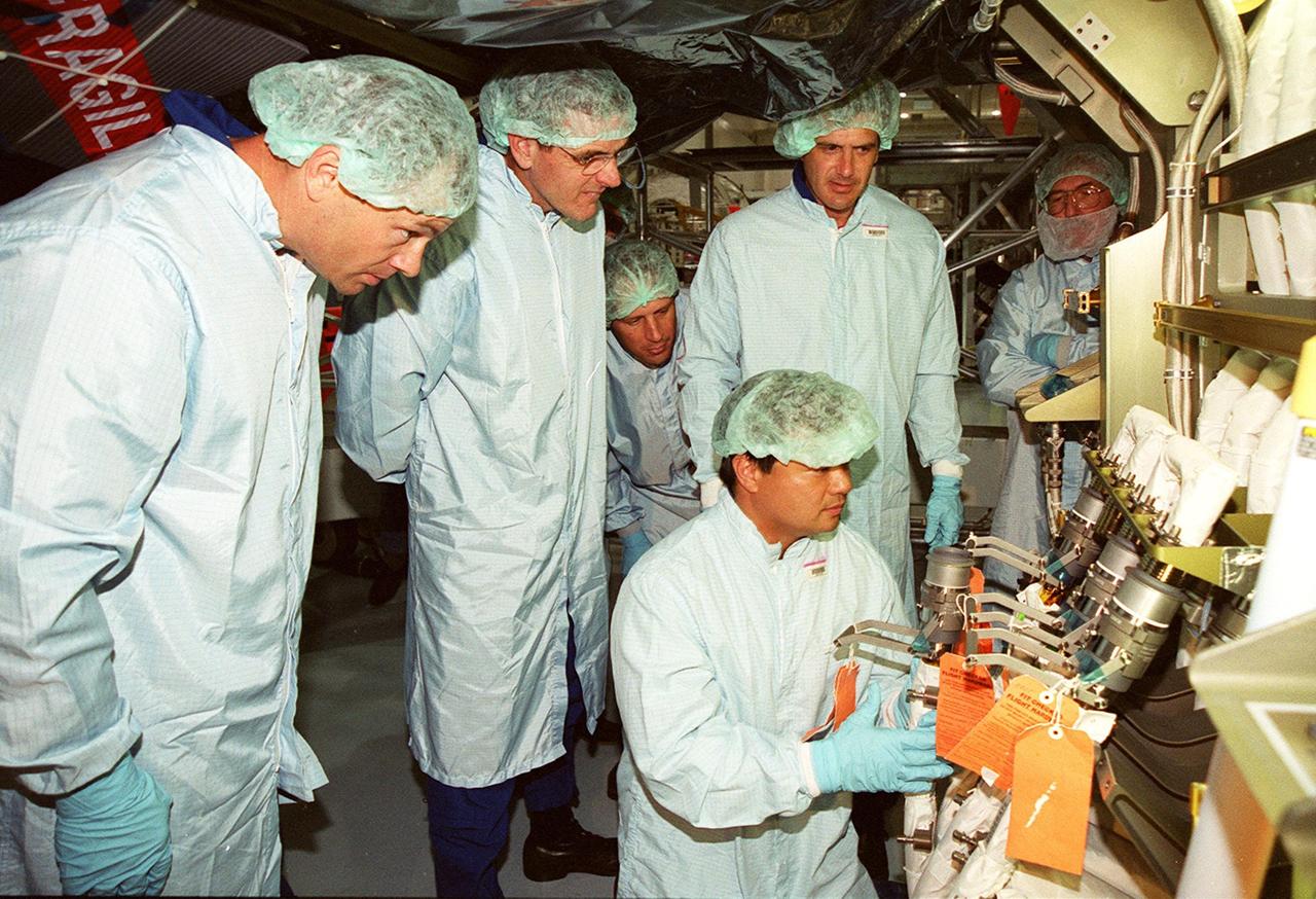 Members of the STS-92 crew check out the Integrated Truss Structure Z1, a component of the International Space Station and payload on their mission. From left are Mission Specialists Michael Lopez-Alegria, Bill McArthur, Jeff Wisoff and (kneeling) Leroy Chiao. They and other crew members are taking part in Crew Equipment Interface Test (CEIT) activities while at KSC. The Z1 truss is an early exterior framework to allow the first U.S. solar arrays on a future flight to be temporarily installed on Unity for early power. STS-92 is scheduled to launch Oct. 5 from launch Pad 39A