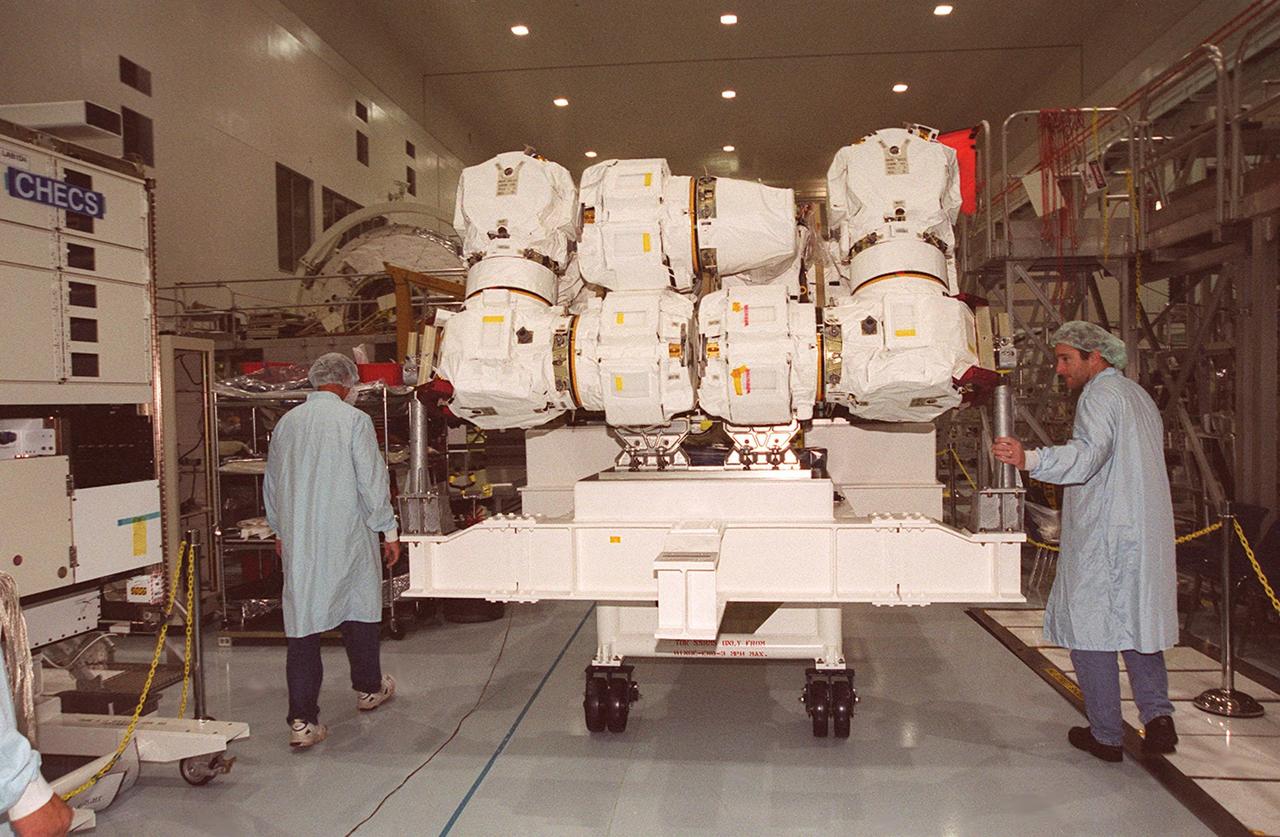 Workers in the Space Station Processing Facility move the Space Station Remote Manipulator System (SSRMS), also known as the “Canadian arm,” to a pallet for testing. The SSRMS is part of Canada’s Mobile Servicing System, an essential component of the International Space Station. This robotic system will play a key role in Space Station assembly and maintenance, moving equipment and supplies around the Station, releasing and capturing satellites, supporting astronauts working in space and servicing instruments and other payloads attached to the Space Station. SSRMS will be on Shuttle mission STS-100, flight 6A, to the Space Station, scheduled for launch April 19, 2001