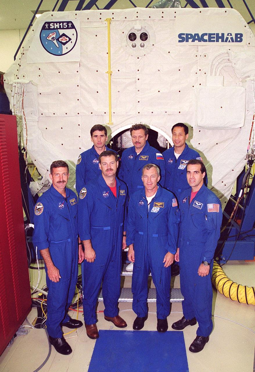 KENNEDY SPACE CENTER, FLA. -- The STS-106 crew poses in front of the SPACEHAB module during Crew Equipment Interface Test activities. From left, in the foreground, are Mission Specialist Daniel C. Burbank, Pilot Scott D. Altman, Commander Terrence W. Wilcutt and Richard A. Mastracchio; in the background are Mission Specialists Yuri I. Malenchenko, Boris V. Morukov and Edward T. Lu. Malenchenko and Morukov represent the Russian Aviation and Space Agency. STS-106 is scheduled to launch Sept. 8, 2000, at 8:31 a.m. EDT from Launch Pad 39B on an 11-day mission to the International Space Station. The seven-member crew will prepare the Space Station for its first resident crew and begin outfitting the newly arrived Zvezda Service Module. They will perform support tasks on orbit, transfer supplies and prepare the Zvezda living quarters for the first long-duration crew, dubbed “Expedition One,” which is due to arrive at the Station in late fall