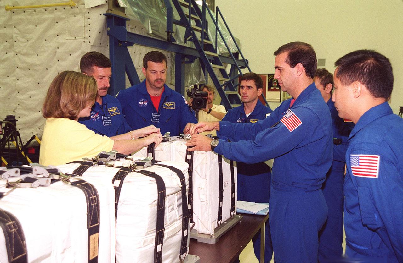 KENNEDY SPACE CENTER, FLA. -- At SPACEHAB members of the STS-106 crew check out equipment they will be using during their mission to the International Space Station. From left are (next to trainer) Mission Specialist Daniel C. Burbank, Pilot Scott D. Altman, and Mission Specialists Yuri I. Malenchenko, Richard A. Mastracchio and Edward T. Lu. Malenchenko and Morukov represent the Russian Aviation and Space Agency. STS-106 is scheduled to launch Sept. 8, 2000, at 8:31 a.m. EDT from Launch Pad 39B on an 11-day mission. The seven-member crew will prepare the Space Station for its first resident crew and begin outfitting the newly arrived Zvezda Service Module. They will perform support tasks on orbit, transfer supplies and prepare the Zvezda living quarters for the first long-duration crew, dubbed “Expedition One,” which is due to arrive at the Station in late fall.