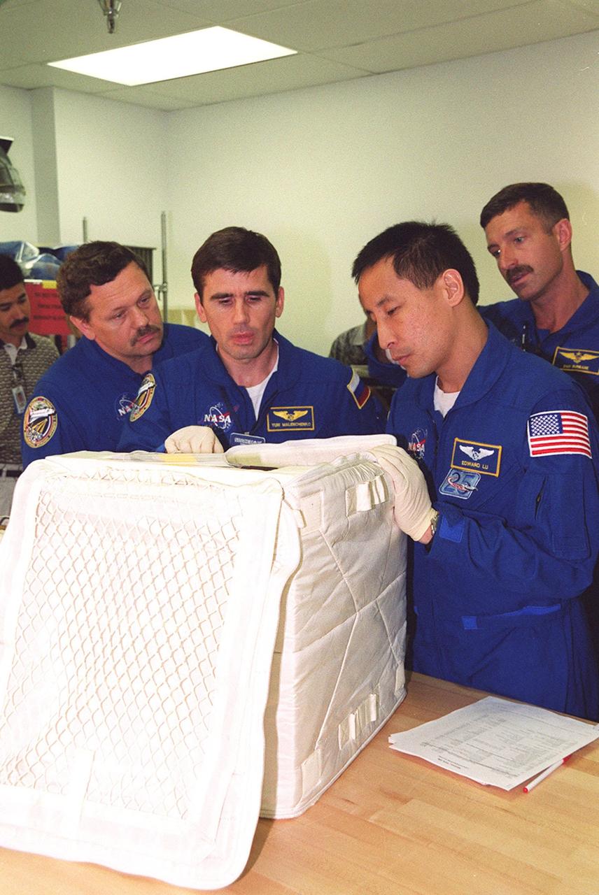 KENNEDY SPACE CENTER, FLA. -- At SPACEHAB members of the STS-106 crew check out equipment they will be using during their mission to the International Space Station. From left to right are Mission Specialists Boris V. Morukov, Yuri I. Malenchenko, Edward T. Lu and Daniel C. Burbank. They and other crew members Commander Terrence W. Wilcutt, Pilot Scott D. Altman and Mission Specialist Robert A. Mastracchio are taking part in Crew Equipment Interface Test activities at KSC. On the 11-day mission, the seven-member crew will perform support tasks on orbit, transfer supplies and prepare the living quarters in the newly arrived Zvezda Service Module for the first long-duration crew, dubbed “Expedition One,” which is due to arrive at the Station in late fall. STS-106 is scheduled to launch Sept. 8, 2000, at 8:31 a.m. EDT from Launch Pad 39B