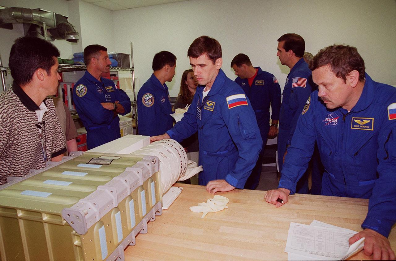 KENNEDY SPACE CENTER, FLA. -- At SPACEHAB members of the STS-106 crew check out equipment they will be using during their mission to the International Space Station. Starting second from left, they are Mission Specialists Daniel C. Burbank, Edward T. Lu, and Yuri I. Malenchenkov; Pilot Scott D. Altman, and Mission Specialists Richard A. Mastracchio and Boris V. Morukov. Not seen is Commander Terrence W. Wilcutt. Malenchenko and Morukov represent the Russian Aviation and Space Agency. The crew is taking part in Crew Equipment Interface Test activities at KSC. On the 11-day mission, the seven-member crew will perform support tasks on orbit, transfer supplies and prepare the living quarters in the newly arrived Zvezda Service Module for the first long-duration crew, dubbed “Expedition One,” which is due to arrive at the Station in late fall. STS-106 is scheduled to launch Sept. 8, 2000, at 8:31 a.m. EDT from Launch Pad 39B
