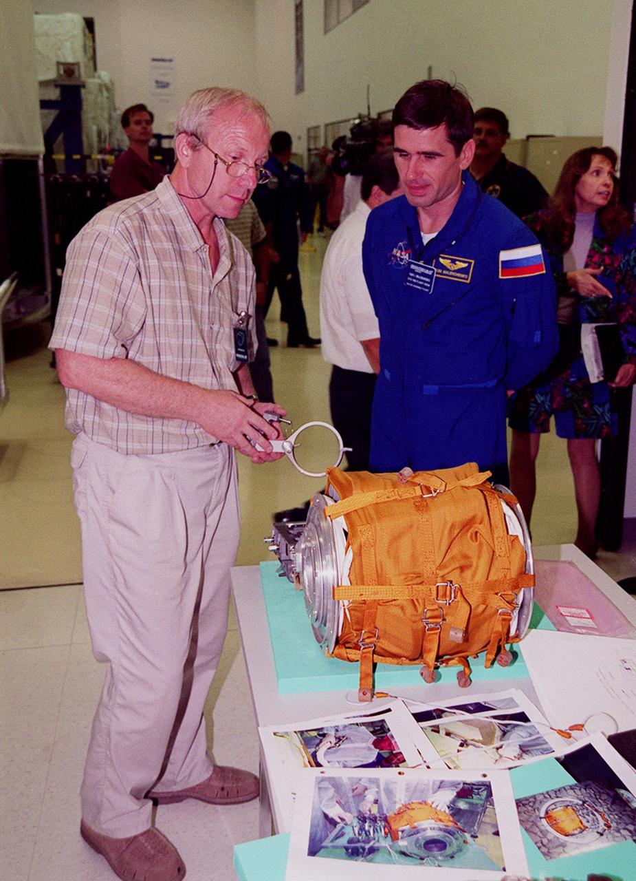 KENNEDY SPACE CENTER, FLA. -- STS-106 Mission Specialist Yuri I. Malenchenko (right) examines equipment at SPACEHAB, part of the payload on the mission to the International Space Station. He and the other crew members Commander Terrence W. Wilcutt, Pilot Scott D. Altman, and Mission Specialists Edward T. Lu, Daniel C. Burbank, Boris V. Morukov and Richard A. Mastracchio are taking part in Crew Equipment Interface Test (CEIT) activities at SPACEHAB. Malenchenko and Morukov represent the Russian Aviation and Space Agency. On the 11-day mission, the seven-member crew will perform support tasks on orbit, transfer supplies and prepare the living quarters in the newly arrived Zvezda Service Module for the first long-duration crew, dubbed "Expedition One," which is due to arrive at the Station in late fall. STS-106 is scheduled to launch Sept. 8, 2000, at 8:31 a.m. EDT from Launch Pad 39B