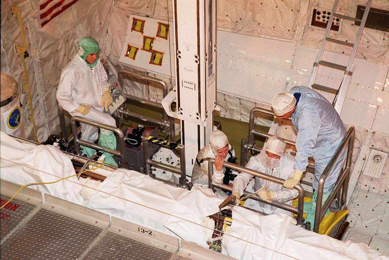 In Orbiter Processing Facility bay 3, members of the STS-106 crew familiarize themselves with equipment in the payload bay of Space Shuttle orbiter Atlantis with the help of KSC employees as part of Crew Equipment Interface Test (CEIT) activities for their mission. The STS-106 crew members are Commander Terrence W. Wilcutt, Pilot Scott D. Altman, and Mission Specialists Edward T. Lu, Daniel C. Burbank, Yuri I. Malenchenko, Boris V. Morukov and Richard A. Mastracchio. Malenchenko and Morukov represent the Russian Aviation and Space Agency. On the 11-day mission, the seven-member crew will perform support tasks on orbit, transfer supplies and prepare the living quarters in the newly arrived Zvezda Service Module for the first long-duration crew, dubbed "Expedition One," which is due to arrive at the Station in late fall. STS-106 is scheduled to launch Sept. 8, 2000, at 8:31 a.m. EDT from Launch Pad 39B
