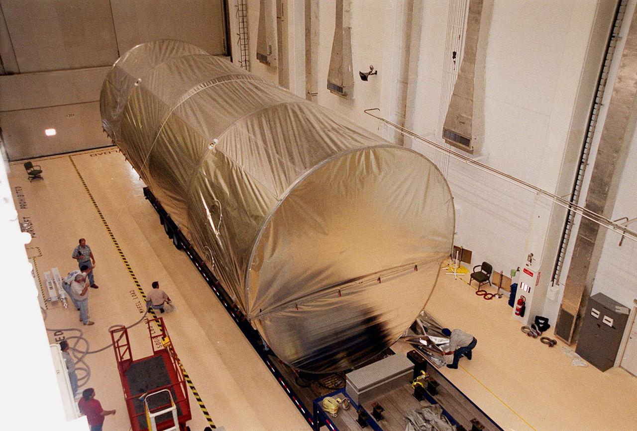 The P-1 truss, a component of the International Space Station, sits inside the Operations and Checkout Building where it will undergo processing. The truss, scheduled to fly in spring of 2002, is part of a total 10-truss, girder-like structure on the Station that will ultimately extend the length of a football field. Astronauts will attach the 14-by-15 foot structure to the port side of the center truss, S0, during the spring assembly flight. The 33,000-pound P-1 will house the thermal radiator rotating joint (TRRJ) that will rotate the Station’s radiators away from the sun to increase their maximum cooling efficiency