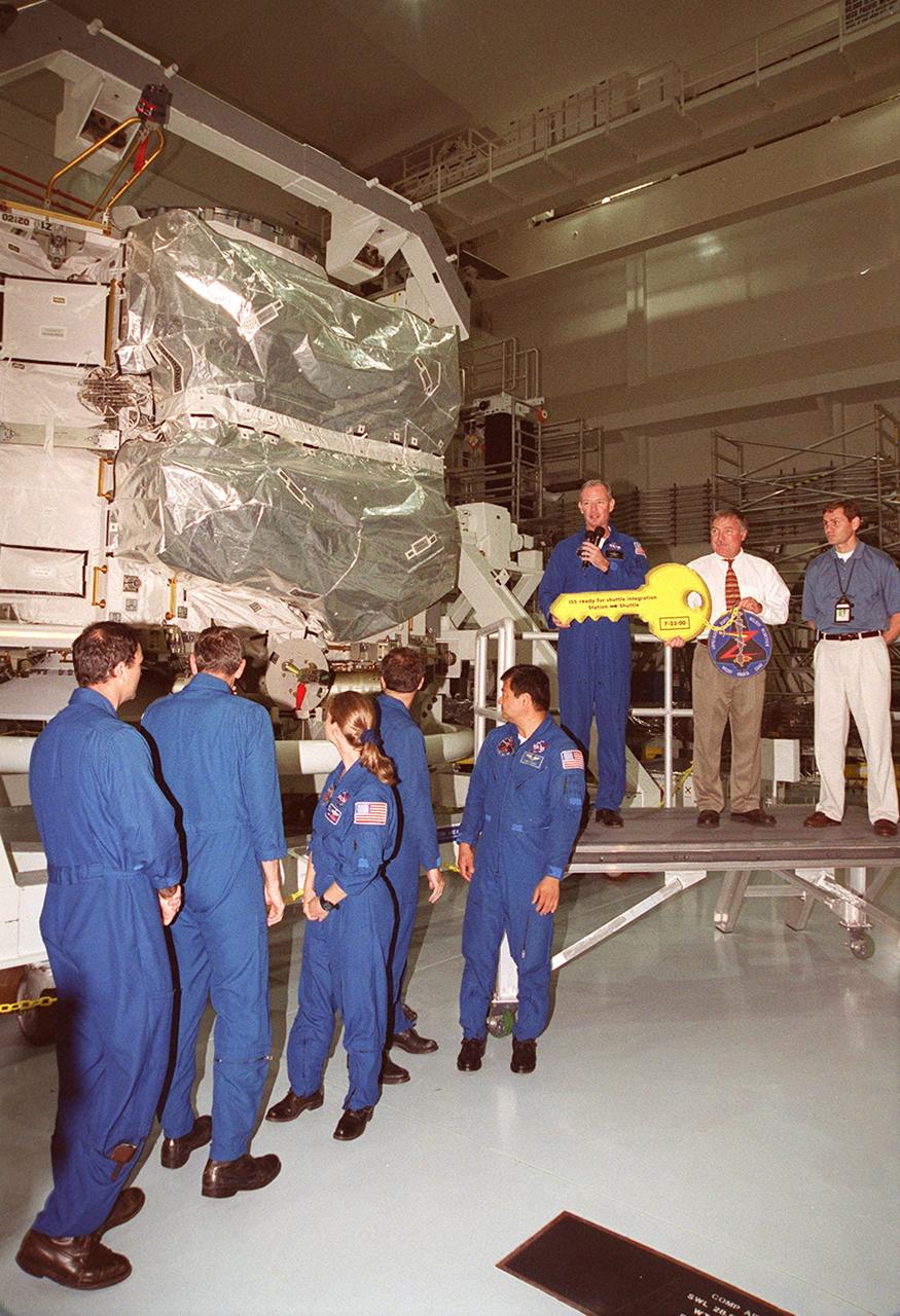 The Zenith-1 (Z-1) Truss is officially presented to NASA by The Boeing Co. on the Space Station Processing Facility floor on July 31. STS-92 Commander Col. Brian Duffy, comments on the presentation. At his side is Tip Talone, NASA director of International Space Station and Payload Processing at KSC. Talone and Col. Duffy received a symbolic key for the truss from John Elbon, Boeing director of ISS ground operations. The Z-1 Truss is the cornerstone truss of the International Space Station and is scheduled to fly in Space Shuttle Discovery's payload pay on STS-92 targeted for launch Oct. 5, 2000. The Z-1 is considered a cornerstone truss because it carries critical components of the Station's attitude, communications, thermal and power control systems as well as four control moment gyros, high and low gain antenna systems, and two plasma contactor units used to disperse electrical charge build-ups. The Z-1 truss and a Pressurized Mating Adapter (PMA-3), also flying to the Station on the same mission, will be the first major U.S. elements flown to the ISS aboard the Shuttle since the launch of the Unity element in December 1998
