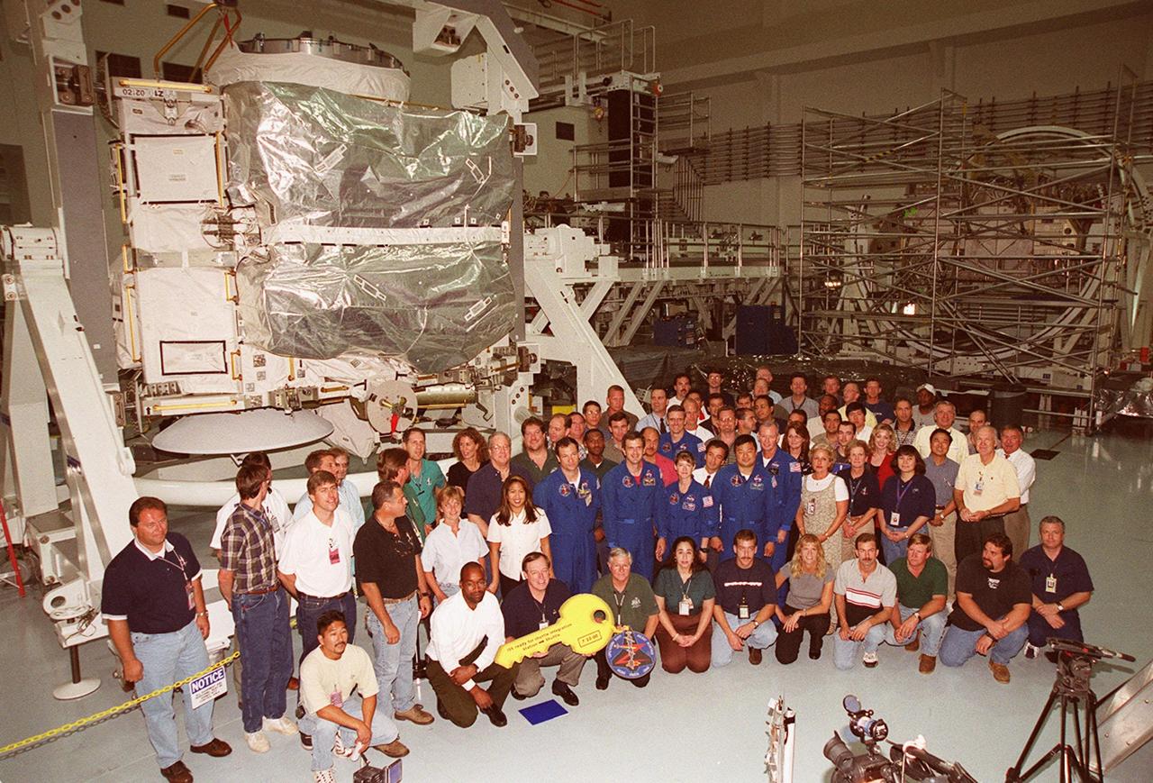 The Zenith-1 (Z-1) Truss is officially presented to NASA by The Boeing Co. on the Space Station Processing Facility floor on July 31. STS-92 Commander Col. Brian Duffy, comments on the presentation. Pictured are The Boeing Co. processing team and STS-92 astronauts. The Z-1 Truss is the cornerstone truss of the International Space Station and is scheduled to fly in Space Shuttle Discovery's payload pay on STS-92 targeted for launch Oct. 5, 2000. The Z-1 is considered a cornerstone truss because it carries critical components of the Station's attitude, communications, thermal and power control systems as well as four control moment gyros, high and low gain antenna systems, and two plasma contactor units used to disperse electrical charge build-ups. The Z-1 truss and a Pressurized Mating Adapter (PMA-3), also flying to the Station on the same mission, will be the first major U.S. elements flown to the ISS aboard the Shuttle since the launch of the Unity element in December 1998