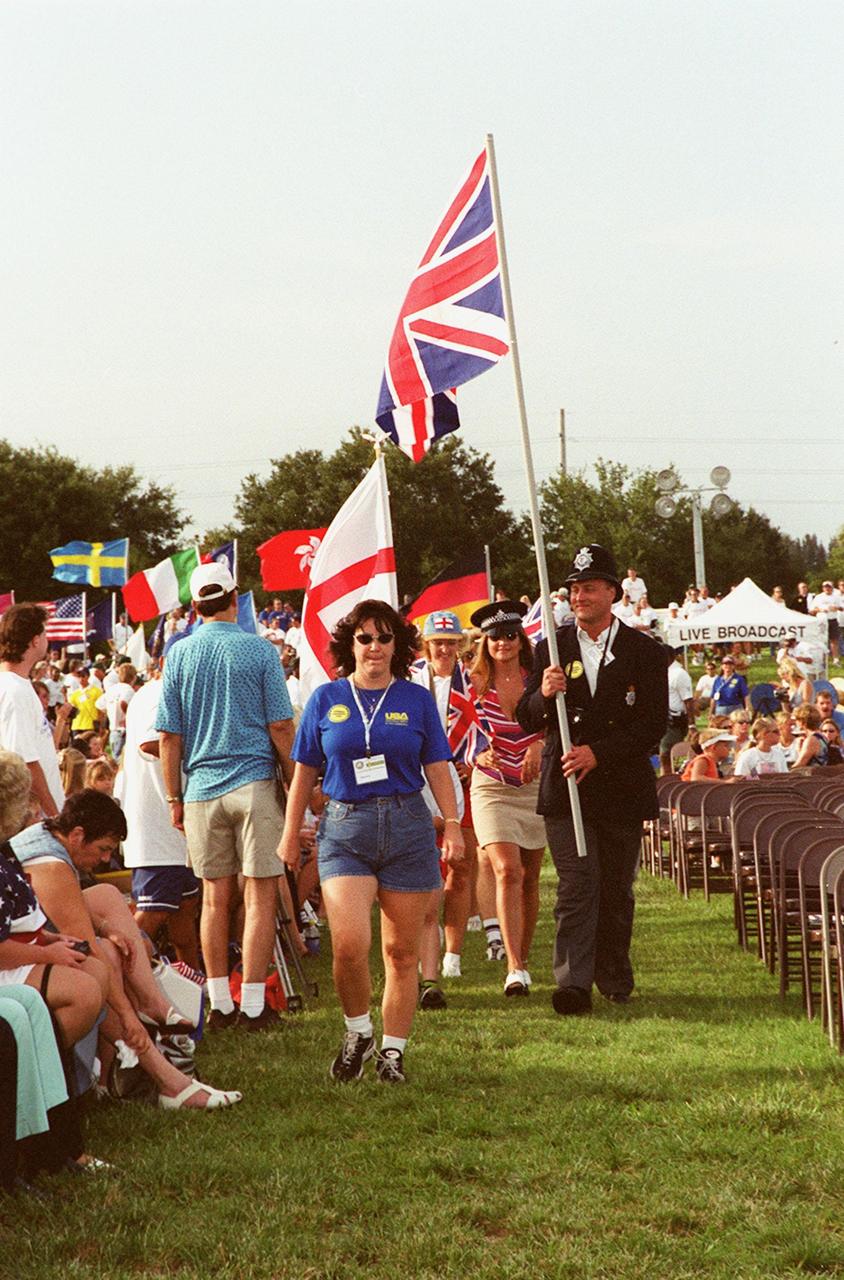 British police officers carry their country’s flag while marching in a parade at the KSC Visitor Complex during opening ceremonies of the 2000 International Law Enforcement Games. More than 1,850 participants and their families took part in the opening, held in the Rocket Garden. The ceremony included parades, torch lighting and a tug of war. The games feature officers from 15 countries and 37 United States in competitions around Brevard County, Fla