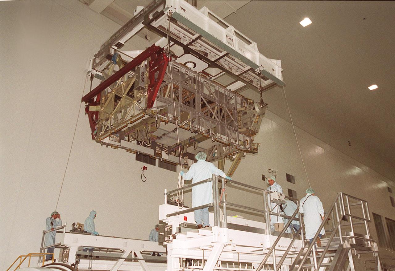 KENNEDY SPACE CENTER, FLA. -- In the Space Station Processing Facility, workers get ready to lower the International Space Station’s P4 truss onto a workstand. Part of the 10-truss, girder-like structure that will ultimately extend the length of a football field, the P4 is the second port truss segment that will attach to the first port truss segment (P1 truss). The P4 is scheduled for mission 12A in September 2002.