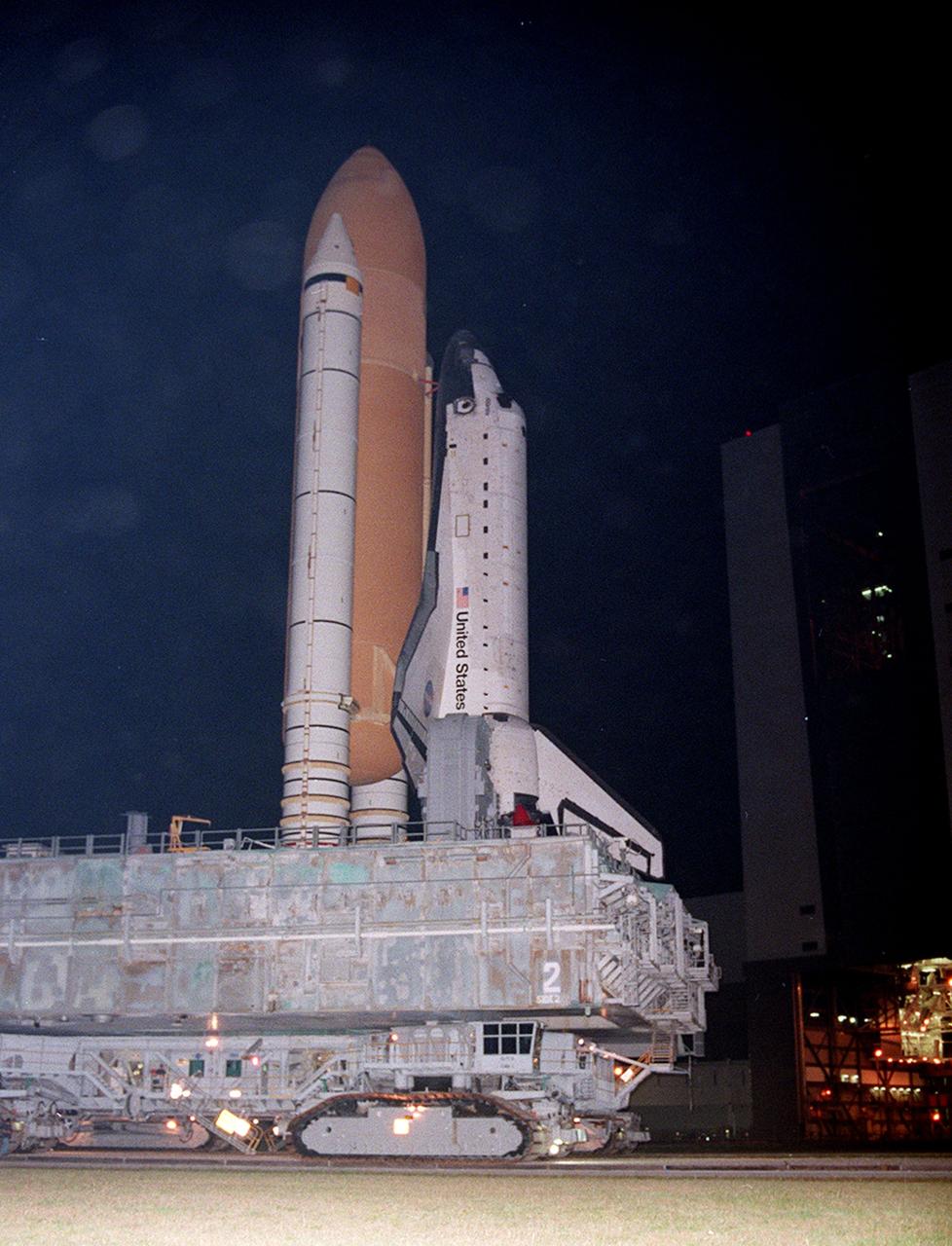 KENNEDY SPACE CENTER, FLA. -- Shuttle Atlantis, with twin solid rocket boosters and external tank atop the Mobile Launcher Platform and crawler-transorter, inches toward high bay 2, on the west side, in the Vehicle Assembly Building (VAB).  For the first time in Space Shuttle history, a fully stacked Shuttle is moving into the bay. The VAB and nearby rock-paved crawlerway have recently undergone major modifications to provide Shuttle fliglht hardware more storage space and protection - "Safe Haven" - from hurricanes or tropical storms.  Atlantis begain moving out of VAB high bay 1 on the east side at 2:59 a.m. EDT.  After the successful "Safe Haven" fit check, Shuttle Atlantis is scheduled to roll out to Launch Pad 39B in preparation for the STS-106 launch on Sept. 8.