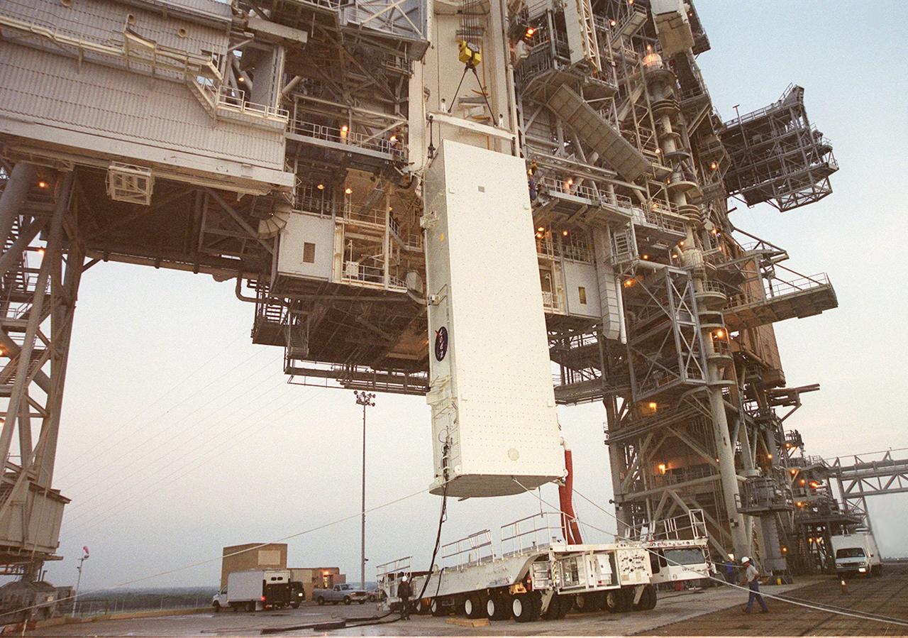 KENNEDY SPACE CENTER, Fla. --  The payload canister is hoisted up alongside the Rotating Service Structure (RSS) on Launch Pad 39B. The canister with its cargo of the SPACEHAB module and Integrated Cargo Carrier will be moved into the Payload Changeout Room near the top of the RSS for transfer to the payload bay of Shuttle Atlantis for mission STS-106. The PCR provides an environmentally controlled facility for the transfer. The 11-day mission to the International Space Station will include service module support tasks on orbit, transfer supplies and outfit the Space Station for the first long-duration crew. Atlantis is scheduled to launch Sept. 8 at 8:31 a.m. EDT.