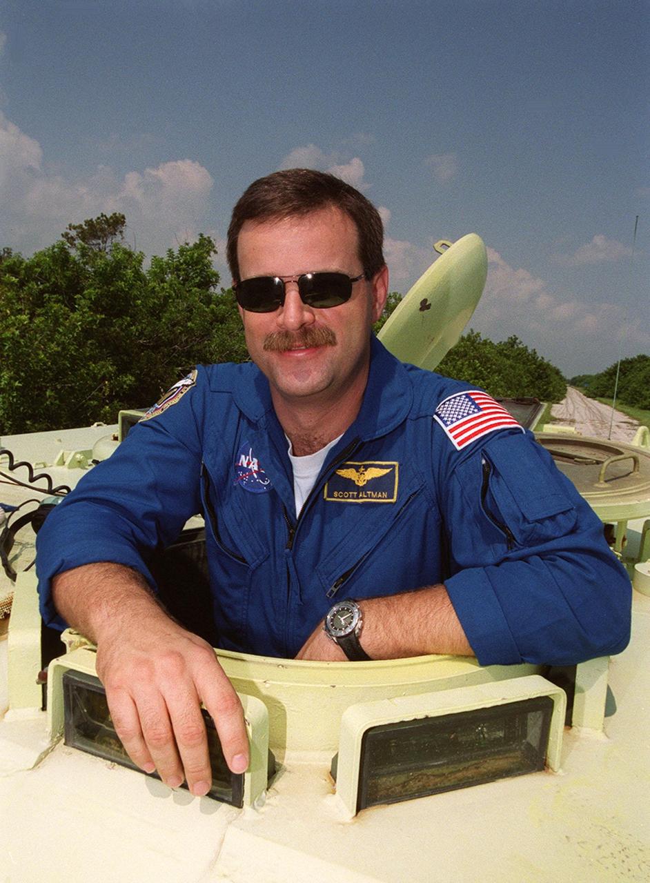 STS-106 Pilot Scott D. Altman is poised to take his turn at driving the M113, an armored personnel carrier, that is part of emergency egress training duringTerminal Countdown Demonstration Test (TCDT) activities. The tracked vehicle could be used by the crew in the event of an emergency at the pad during which the crew must make a quick exit from the area. The TCDT also provides simulated countdown exercises and opportunities to inspect the mission payloads in the orbiter’s payload bay. STS-106 is scheduled to launch Sept. 8, 2000, at 8:31 a.m. EDT from Launch Pad 39B. On the 11-day mission, the seven-member crew will perform support tasks on orbit, transfer supplies and prepare the living quarters in the newly arrived Zvezda Service Module. The first long-duration crew, dubbed “Expedition One,” is due to arrive at the Station in late fall