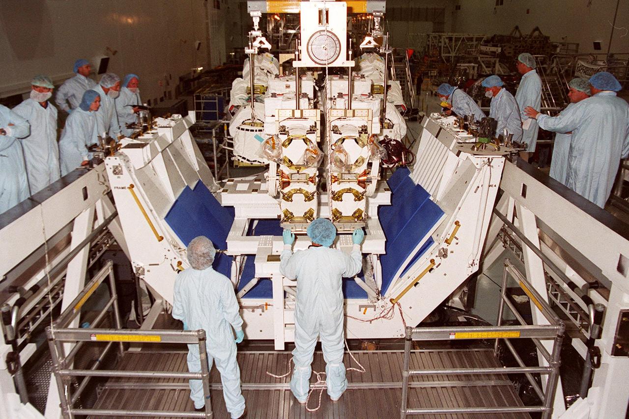 The Canadian Space Agency’s Space Station Remote Manipulator System (SSRMS) is lowered onto a test stand in the Space Station Processing Facility. At the test stand the SSRMS will be mated to its payload carrier. This pallet will later be installed into the payload bay of Space Shuttle Endeavour for launch to the International Space Station on STS-100 in April 2001. The 56-foot-long arm will be the primary means of transferring payloads between the orbiter payload bay and the Station. Its three segments comprise seven joints for highly flexible land precise movement, making it capable of moving around the Station’s exterior like an inchworm