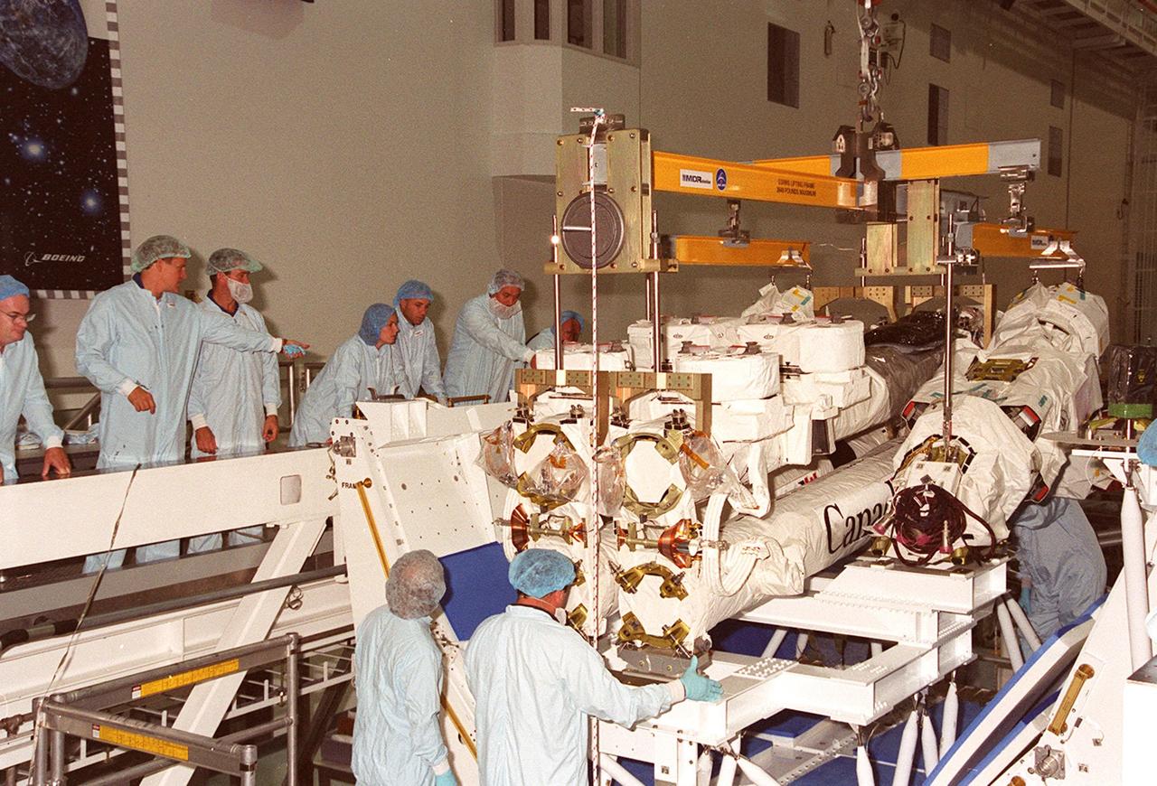 The Canadian Space Agency’s Space Station Remote Manipulator System (SSRMS) finally rests on a test stand in the Space Station Processing Facility. At the test stand the SSRMS will be mated to its payload carrier. This pallet will later be installed into the payload bay of Space Shuttle Endeavour for launch to the International Space Station on STS-100 in April 2001. The 56-foot-long arm will be the primary means of transferring payloads between the orbiter payload bay and the Station. Its three segments comprise seven joints for highly flexible land precise movement, making it capable of moving around the Station’s exterior like an inchworm