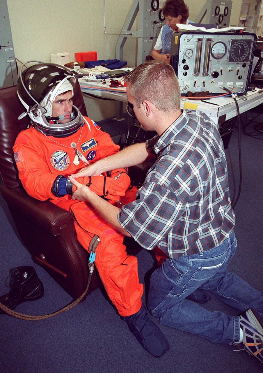 STS-106 Mission Specialist Yuri I. Malenchenko, with the Russian Aviation and Space Agency, has his launch and entry suit checked as part of fit check during Terminal Countdown Demonstration Test activities (TCDT). The TCDT also provides emergency egress training, simulated countdown exercises and opportunities for the crew to inspect the mission payloads in the orbiter’s payload bay. STS-106 is scheduled to launch Sept. 8, 2000, at 8:31 a.m. EDT from Launch Pad 39B. On the 11-day mission, the seven-member crew will perform support tasks on orbit, transfer supplies and prepare the living quarters in the newly arrived Zvezda Service Module. The first long-duration crew, dubbed “Expedition One,” is due to arrive at the Station in late fall