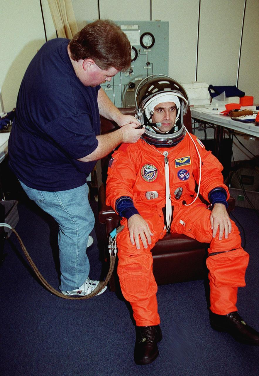 STS-106 Mission Specialist Richard A. Mastracchio has his helmet equipment adjusted during fit check, part of Terminal Countdown Demonstration Test activities (TCDT). The TCDT also provides emergency egress training, simulated countdown exercises and opportunities for the crew to inspect the mission payloads in the orbiter’s payload bay. STS-106 is scheduled to launch Sept. 8, 2000, at 8:31 a.m. EDT from Launch Pad 39B. On the 11-day mission, the seven-member crew will perform support tasks on orbit, transfer supplies and prepare the living quarters in the newly arrived Zvezda Service Module. The first long-duration crew, dubbed “Expedition One,” is due to arrive at the Station in late fall