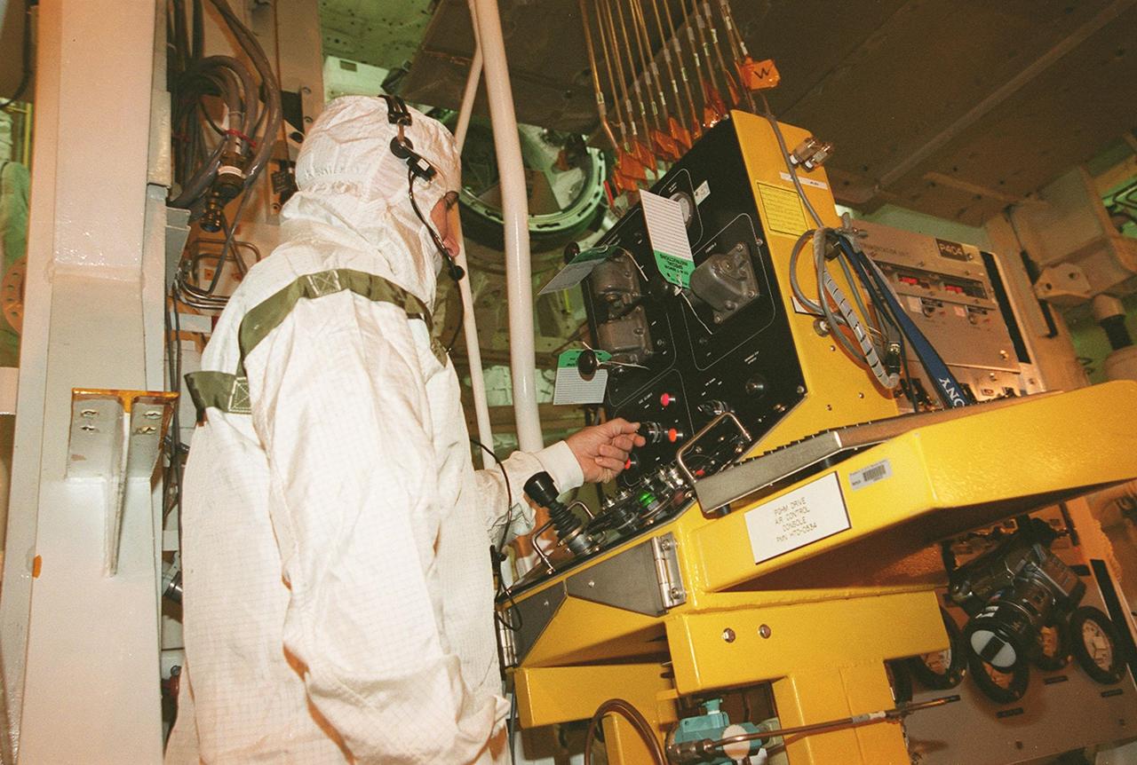 KENNEDY SPACE CENTER, FLA. -- During the transfer the STS-106 payload to Atlantis on Launch Pad 39-B, a technician turns a switch to move the Payload Ground Handling Mechanism (PGHM). The mechanism is located inside the Payload Changeout Room (PCR) of each shuttle launch pad’s Rotating Service Structure. The PGHM (pronounced pigem) removes payloads from a transportation canister and installs them into the orbiter. It is essentially NASA’s largest fork-lift