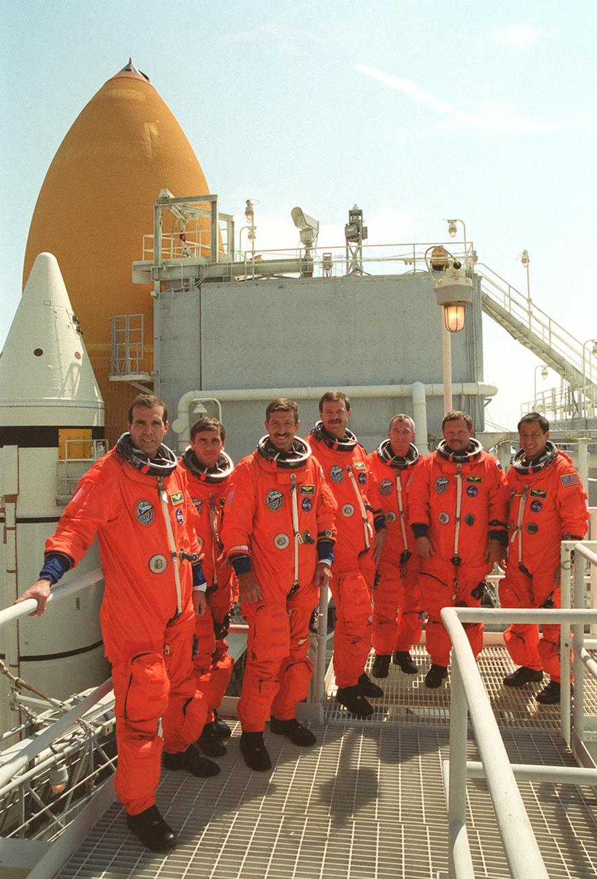 KENNEDY SPACE CENTER, Fla. -- At the 217-foot level of the Rotating Service Structure on Launch Pad 39B, the STS-106 crew takes a break during Terminal Countdown Demonstration Activities (TCDT) for a group photo. Pictured from left are Mission Specialists Richard A. Mastracchio, Yuri I. Malenchenko and Daniel C. Burbank; Pilot Scott D. Altman; Commander Terrence W. Wilcutt; and Mission Specialists Boris V. Morukov and Edward T. Lu. The TCDT provides the crew with emergency egress training, opportunities to inspect their mission payload in the orbiter’s payload bay, and a simulated launch countdown. STS-106 is scheduled to launch Sept. 8, 2000, at 8:31 a.m. EDT from Launch Pad 39B. On the 11-day mission, the seven-member crew will perform support tasks on orbit, transfer supplies and prepare the living quarters in the newly arrived Zvezda Service Module. The first long-duration crew, dubbed “Expedition One,” is due to arrive at the Station in late fall