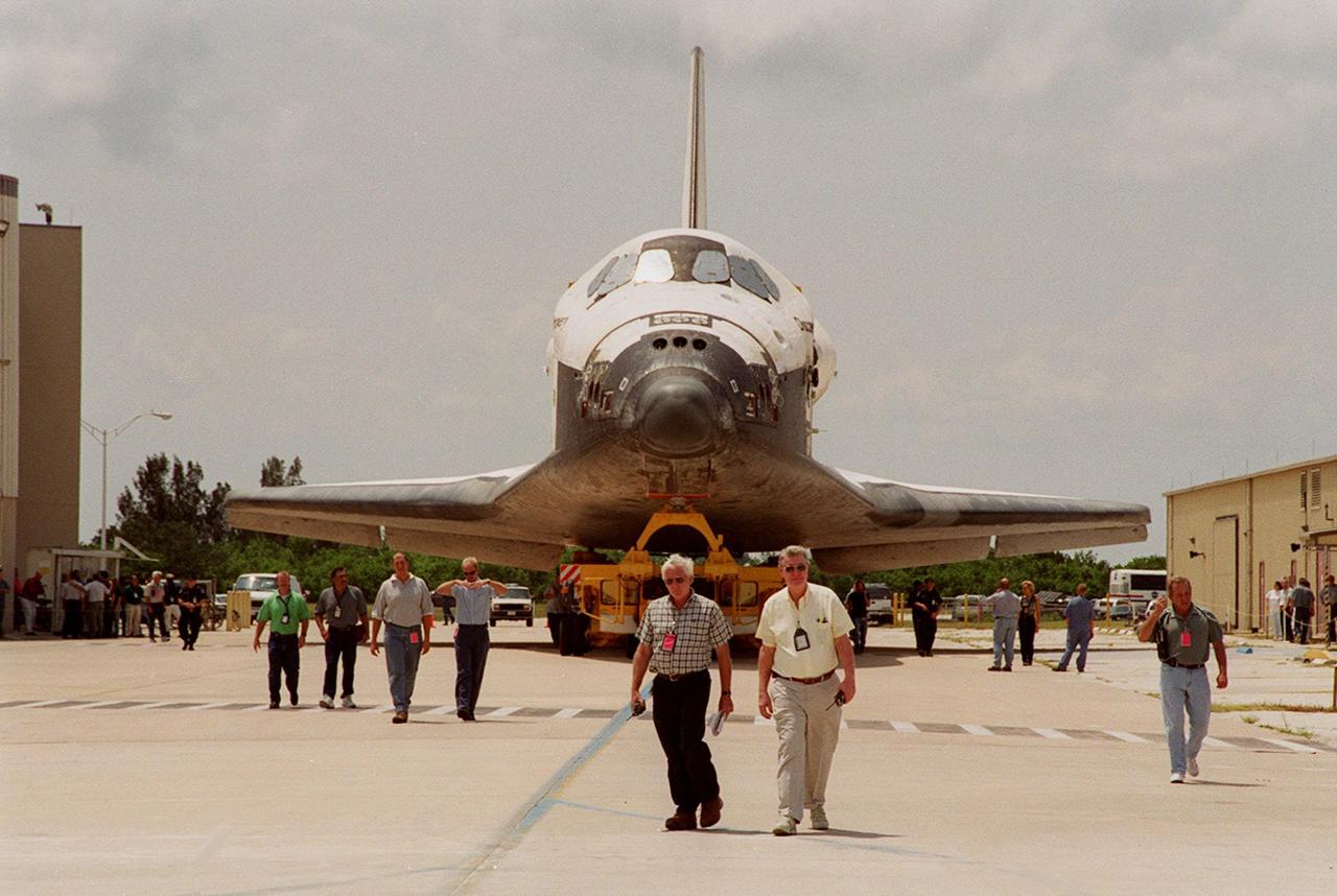 KENNEDY SPACE CENTER, FLA. -- KSC employees chaperone the transfer of the orbiter Discovery from Orbiter Processing Facility (OPF) bay 1 to OPF bay 3 where ongoing payload and ground processing assessments will be completed. Managers will then determine when to roll the orbiter to the Vehicle Assembly Building for stacking with the external tank and solid rocket boosters, and when to roll out to Launch Pad 39A. Discovery is scheduled to launch Oct. 5 at 9:30 p.m. EDT on mission STS-92, which will be the 100th flight in the Shuttle program