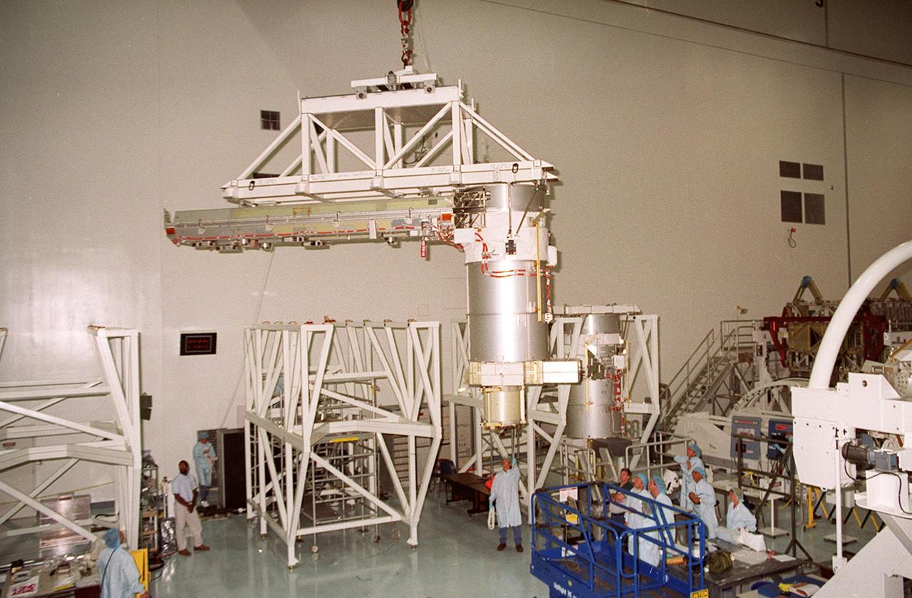 In the Space Station Processing Facility, Solar Array Wing-3, an element of the International Space Station, is lifted from a work stand to move it to the Integrated Electronic Assembly for testing. The solar array is scheduled to be launched on STS-97 in late November along with the P6 truss. The Station’s electrical power system (EPS) will use eight photovoltaic solar arrays to convert sunlight to electricity. Each of the eight solar arrays will be 112 feet long by 39 feet wide. The solar arrays are mounted on a “blanket” that can be folded like an accordion for delivery. Once in orbit, astronauts will deploy the blankets to their full size. Gimbals will be used to rotate the arrays so that they will face the Sun to provide maximum power to the Space Station