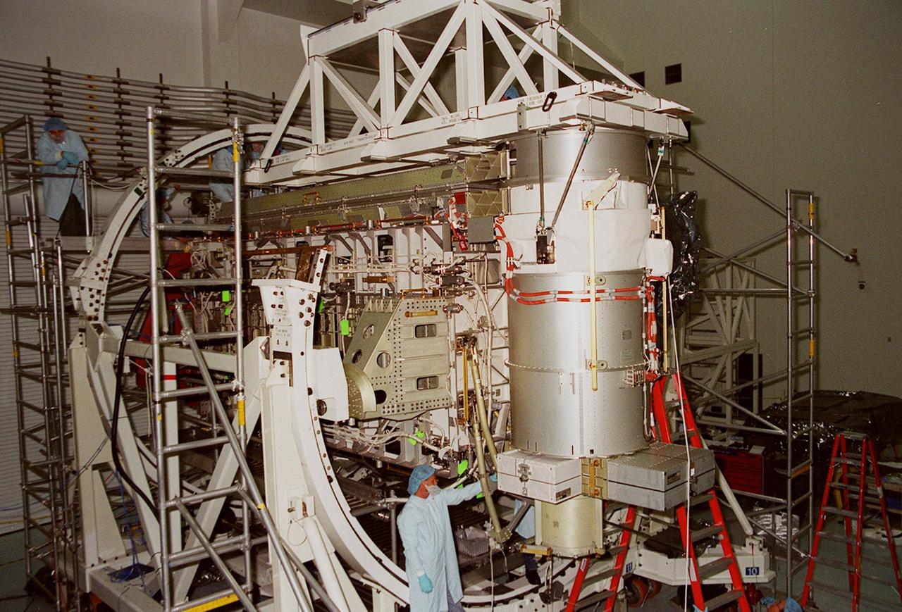 In the Space Station Processing Facility, Solar Array Wing-3, a component of the International Space Station, is installed in the Integrated Electronic Assembly where it will be tested. The solar array is scheduled to be launched on STS-97 in late November along with the P6 truss. The Station’s electrical power system (EPS) will use eight photovoltaic solar arrays to convert sunlight to electricity. Each of the eight solar arrays will be 112 feet long by 39 feet wide. The solar arrays are mounted on a “blanket” that can be folded like an accordion for delivery. Once in orbit, astronauts will deploy the blankets to their full size. Gimbals will be used to rotate the arrays so that they will face the Sun to provide maximum power to the Space Station