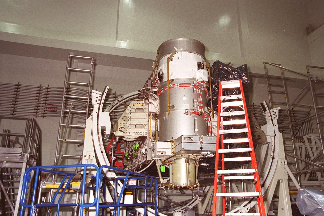 In the Space Station Processing Facility, Solar Array Wing-3, a component of the International Space Station, is installed in the Integrated Electronic Assembly where it will be tested. The solar array is scheduled to be launched on STS-97 in late November along with the P6 truss. The Station’s electrical power system (EPS) will use eight photovoltaic solar arrays to convert sunlight to electricity. Each of the eight solar arrays will be 112 feet long by 39 feet wide. The solar arrays are mounted on a “blanket” that can be folded like an accordion for delivery. Once in orbit, astronauts will deploy the blankets to their full size. Gimbals will be used to rotate the arrays so that they will face the Sun to provide maximum power to the Space Station